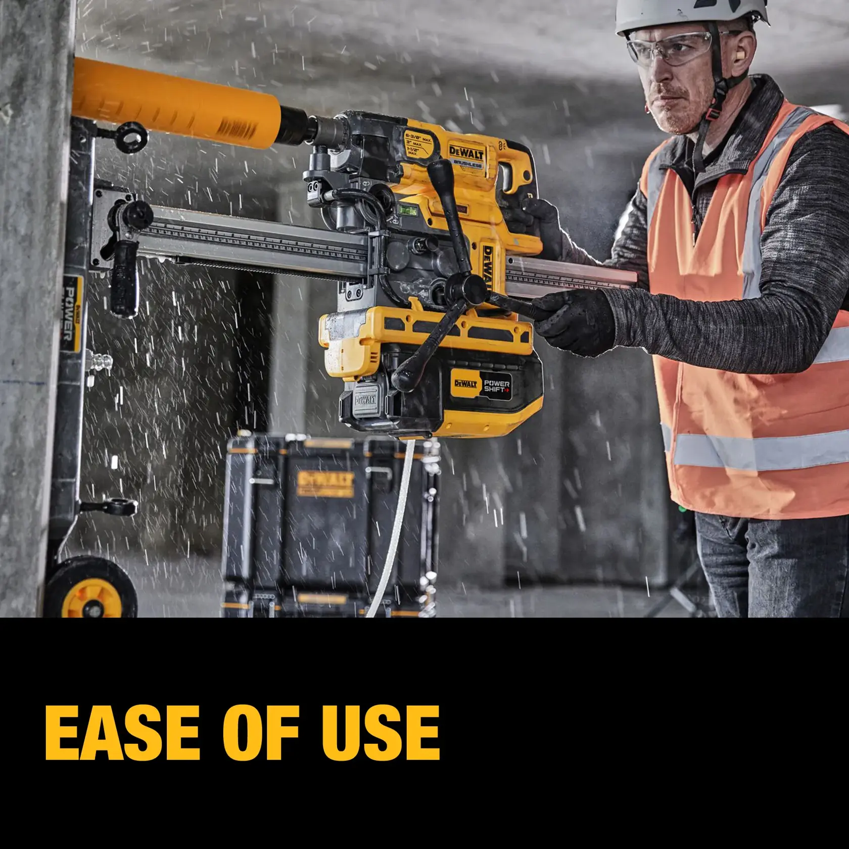 A construction worker wearing a safety vest and helmet uses a DEWALT power tool to drill into a concrete pillar. Water is spraying as the tool operates, and a DEWALT equipment case can be seen in the background. The text 'EASE OF USE' is displayed at the bottom.