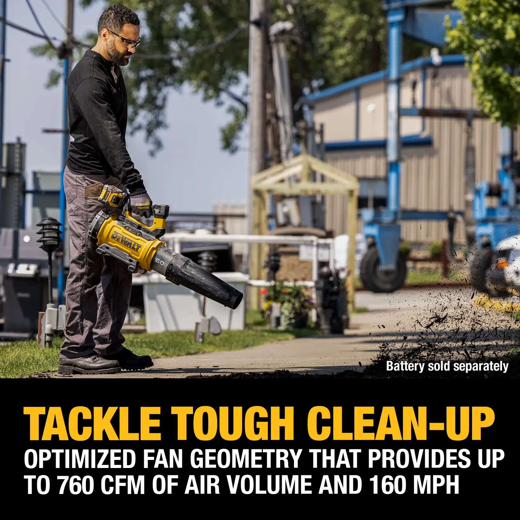 Person blowing mulch with 60V blower