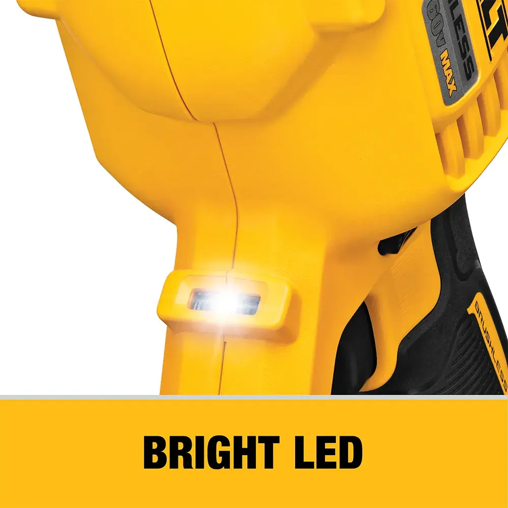 A person using a DEWALT cordless drill to bore a hole in a wooden frame inside a construction site. Sawdust can be seen as the drill operates.