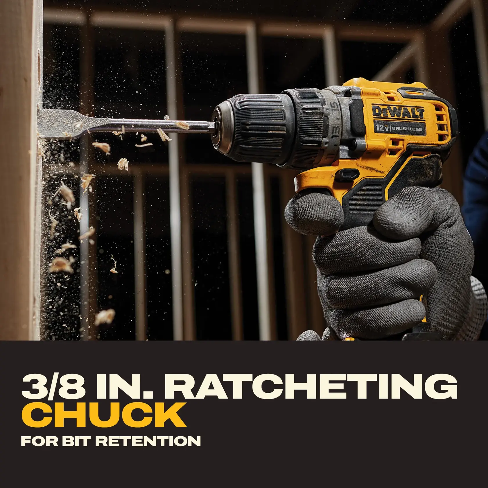 A DEWALT 12V brushless cordless drill is being used to drill into a wooden beam, with wood chips flying from the surface. The person operating the drill is wearing protective gloves. The text at the bottom reads '3/8 IN. RATCHETING CHUCK FOR BIT RETENTION.'