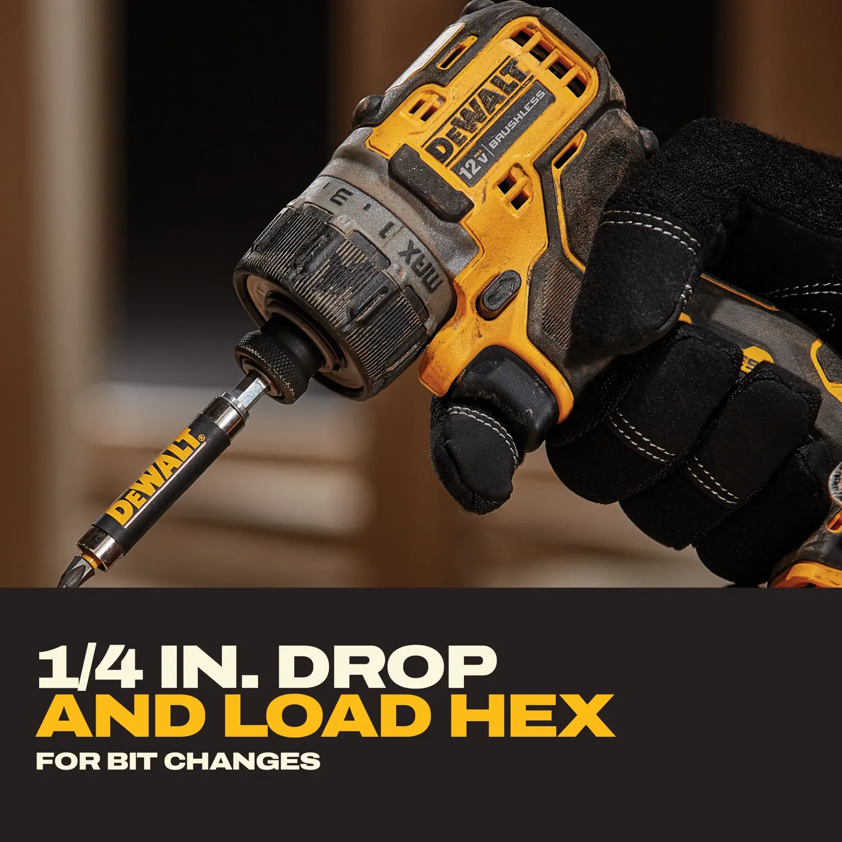 Close-up of a gloved hand holding a DEWALT 12V brushless power drill with a 1/4 inch drop and load hex bit attached. The image highlights easy bit changes with the text '1/4 IN. DROP AND LOAD HEX FOR BIT CHANGES.'