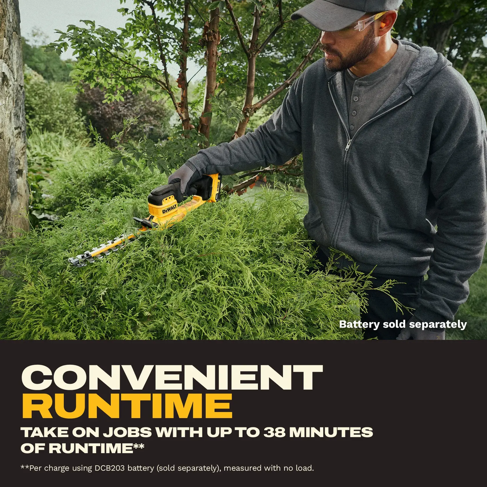 A person with a blurred face, wearing a gray hoodie and gloves, is using a yellow DEWALT cordless hedge trimmer (SKU: DCHT823B) to trim bushes in an outdoor garden. The image highlights the product's convenient runtime of up to 38 minutes with the DCB203 battery, which is sold separately.