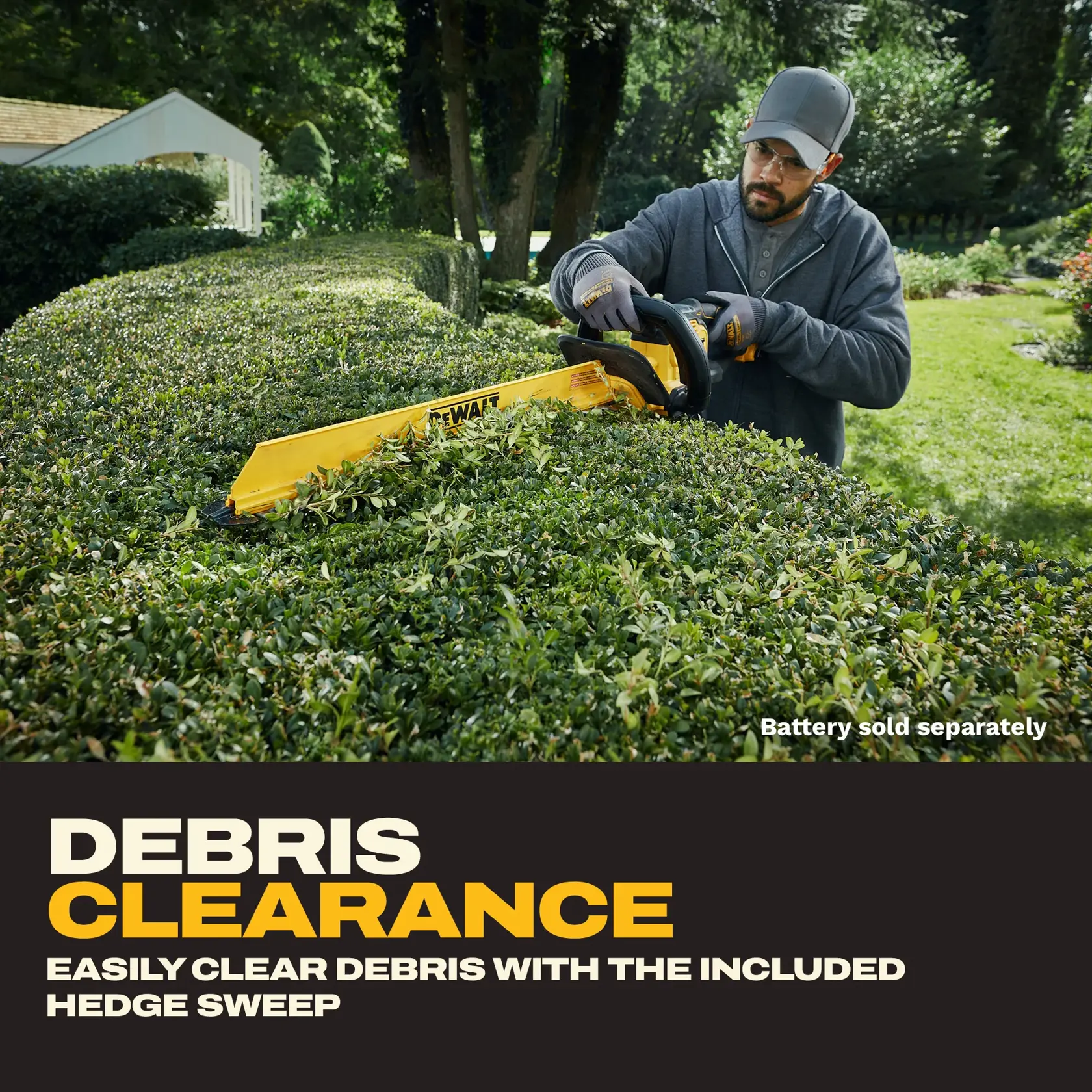 A person wearing gloves and a cap uses a DEWALT hedge trimmer with a yellow blade to clear debris from a hedge in a garden. The text highlights debris clearance and notes that the battery is sold separately.