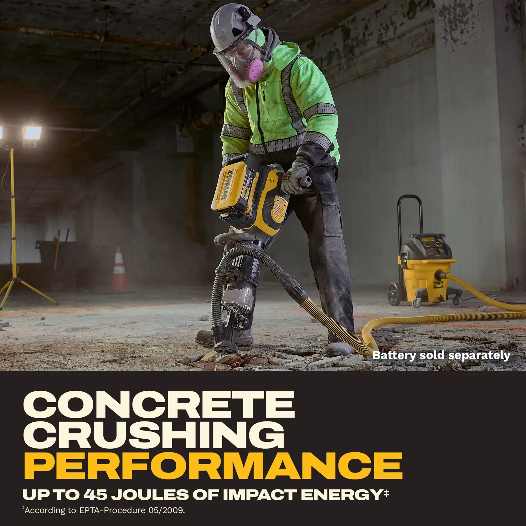 A construction worker in protective gear using a DEWALT power tool to break concrete on a worksite. The worker is wearing a helmet, high-visibility jacket, and face mask. A yellow vacuum unit is connected to the tool, and there is safety lighting and a traffic cone in the background. Text on the image highlights concrete crushing performance with up to 45 joules of impact energy. Battery sold separately.