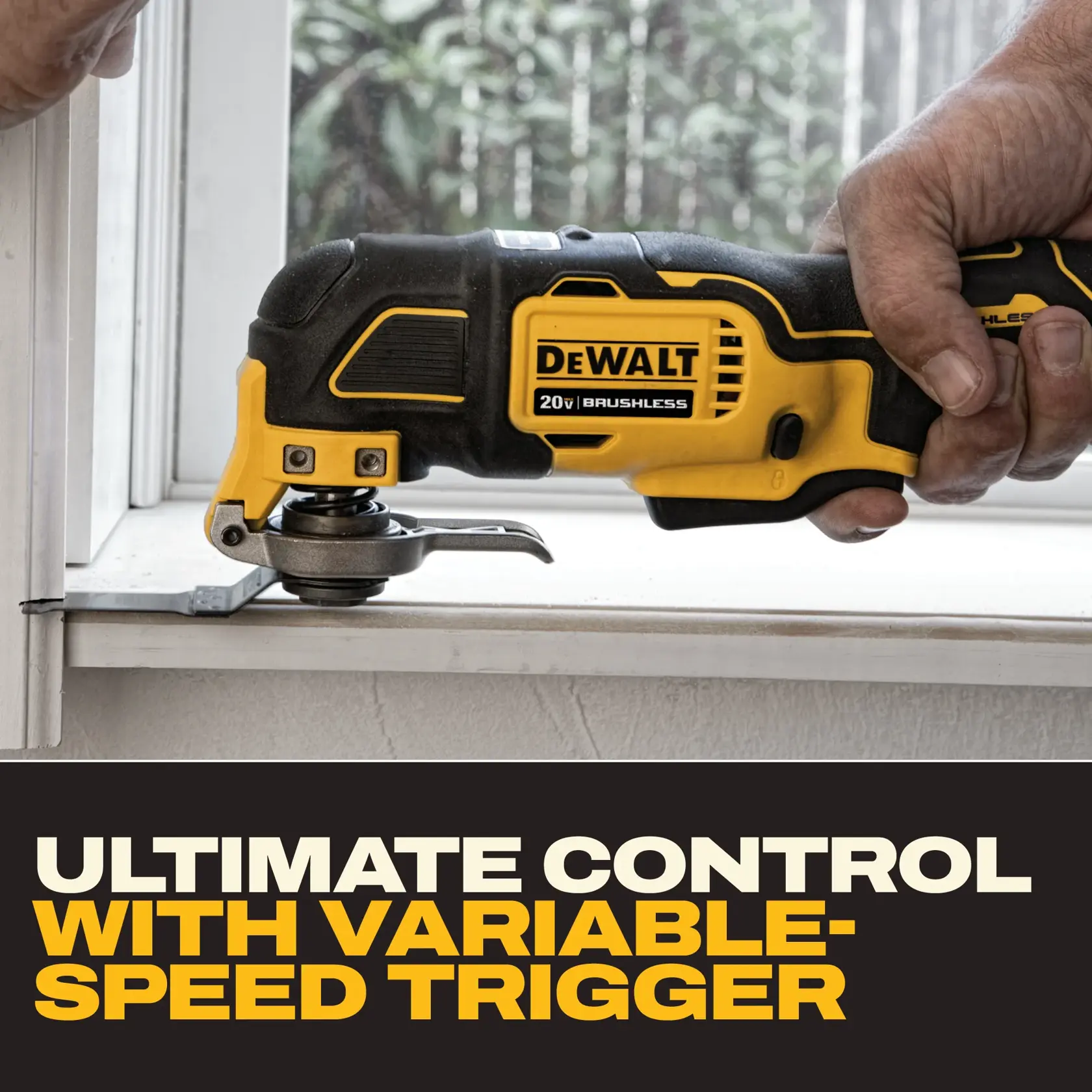 A person using a DEWALT cordless oscillating multi-tool to cut or trim around a plastic pipe attached to a concrete wall.