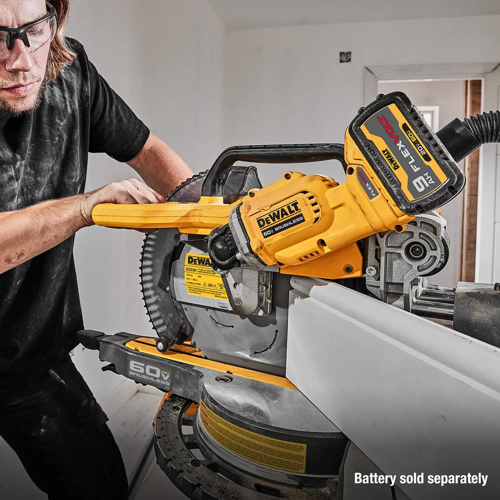 Man using DCS781 Miter Saw with battery sold separately caption