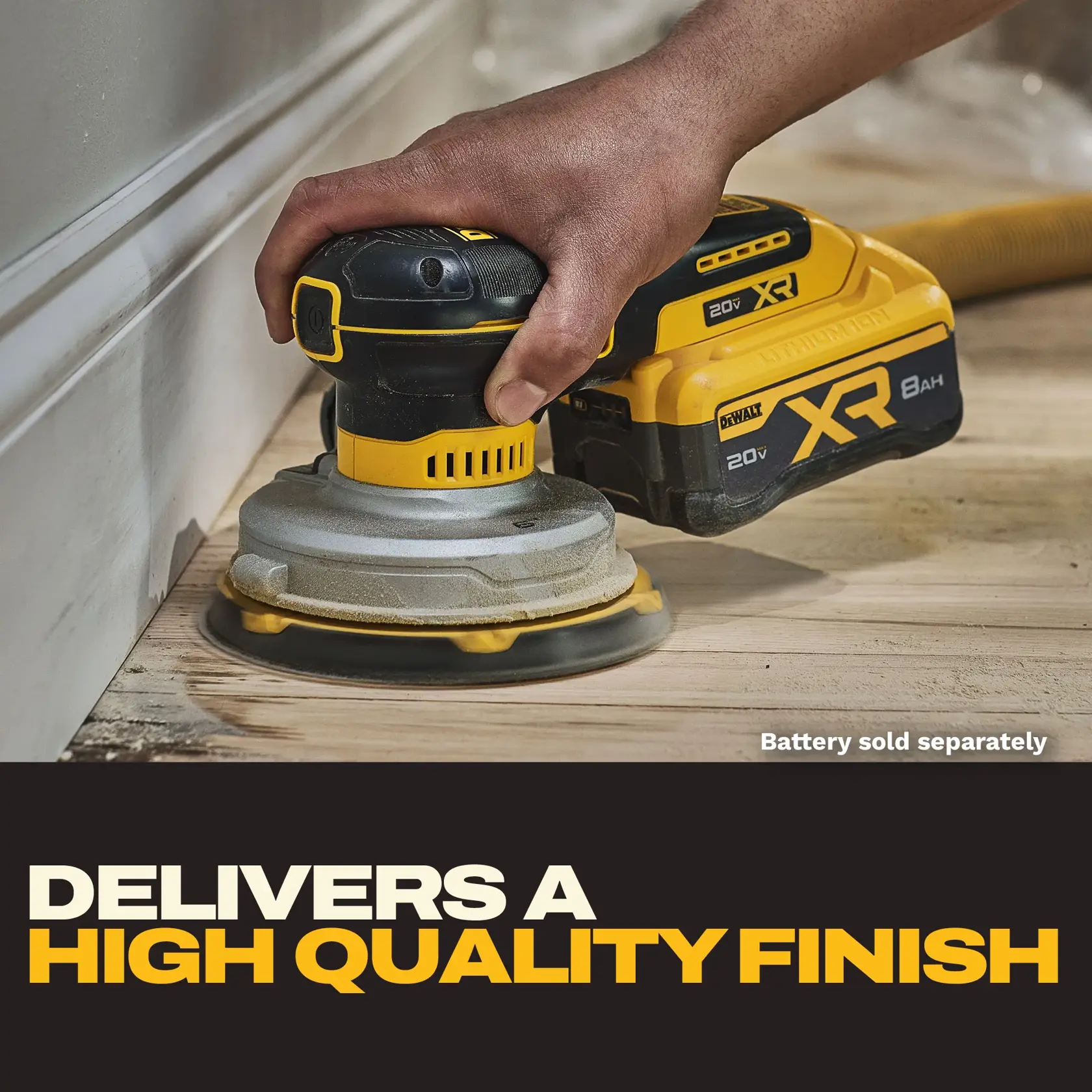 A close-up of a hand using a DEWALT cordless sander on a wooden floor near a white wall trim. The sander is labeled XR and 20V, and there is a note indicating that the battery is sold separately. Bold text below reads: 'Delivers a high quality finish.'