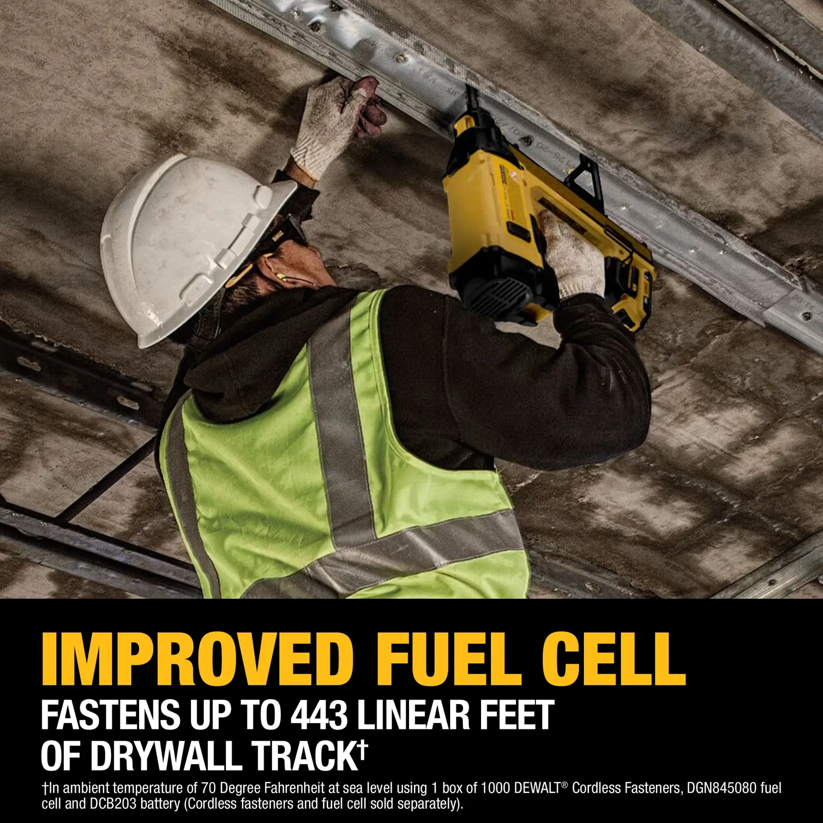 A construction worker wearing a white hard hat, safety glasses, gloves, and a green safety vest is using a yellow DEWALT cordless fastener tool to attach a metal drywall track to the ceiling. Promotional text at the bottom highlights the improved fuel cell and the tool’s ability to fasten up to 443 linear feet of drywall track.
