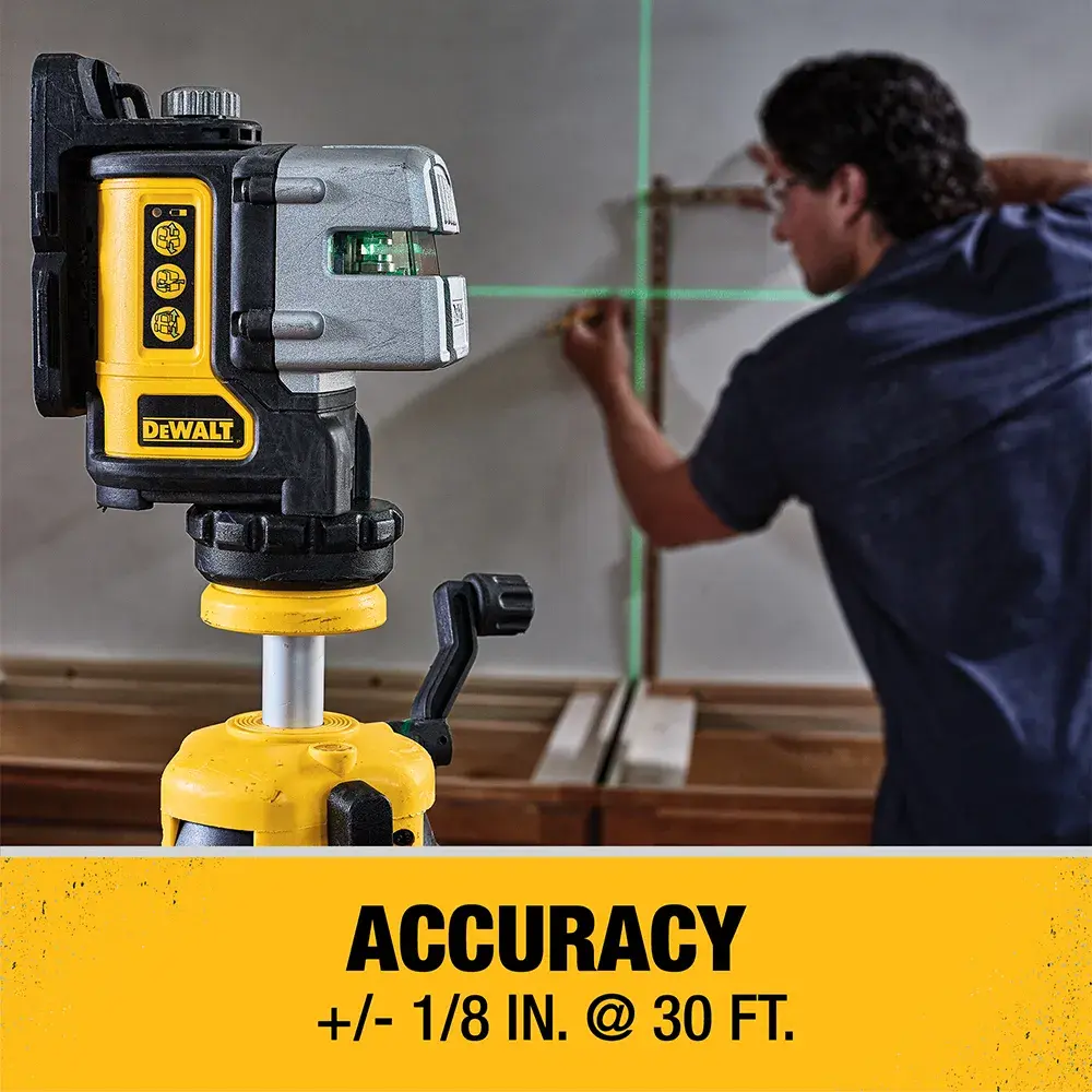 A DEWALT laser level device mounted on a tripod, projecting green laser lines onto a wall while a person marks measurements. Text below states 'ACCURACY +/- 1/8 IN. @ 30 FT.'