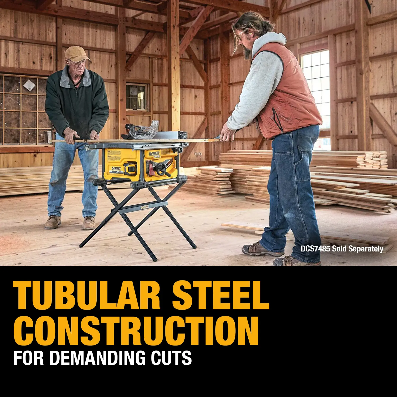 Two people are using a DEWALT table saw mounted on a tubular steel stand inside a wooden workshop. Stacks of lumber are visible in the background. The text highlights 'Tubular steel construction for demanding cuts.' The table saw model DCS7485 is indicated as sold separately.