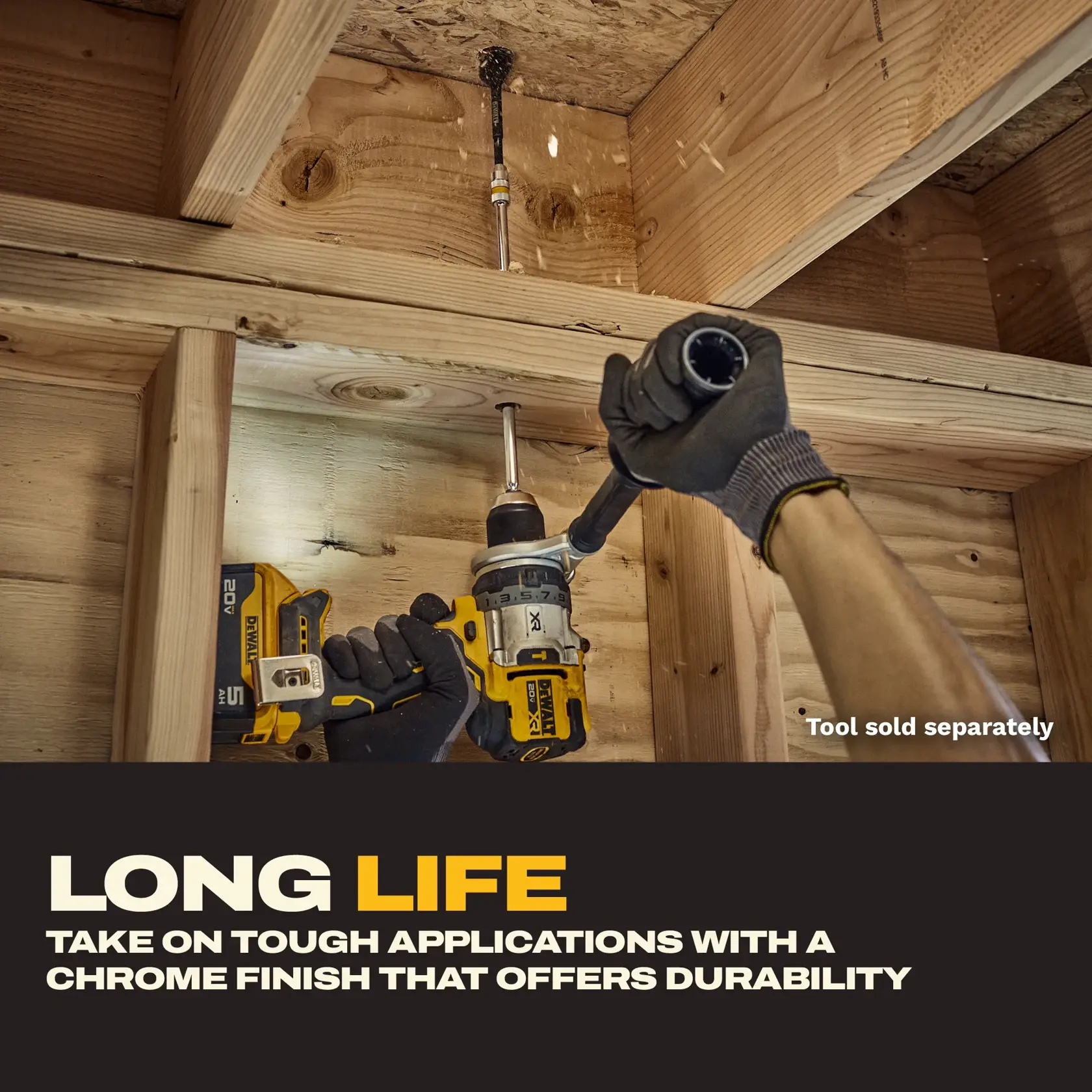 A person uses a DEWALT drill with a long drill bit attachment to bore a hole in a wooden ceiling frame. The drill attachment is shown providing extended reach for tough applications. Text on the image highlights the product's long life and chrome finish for durability. The tool is noted as being sold separately.