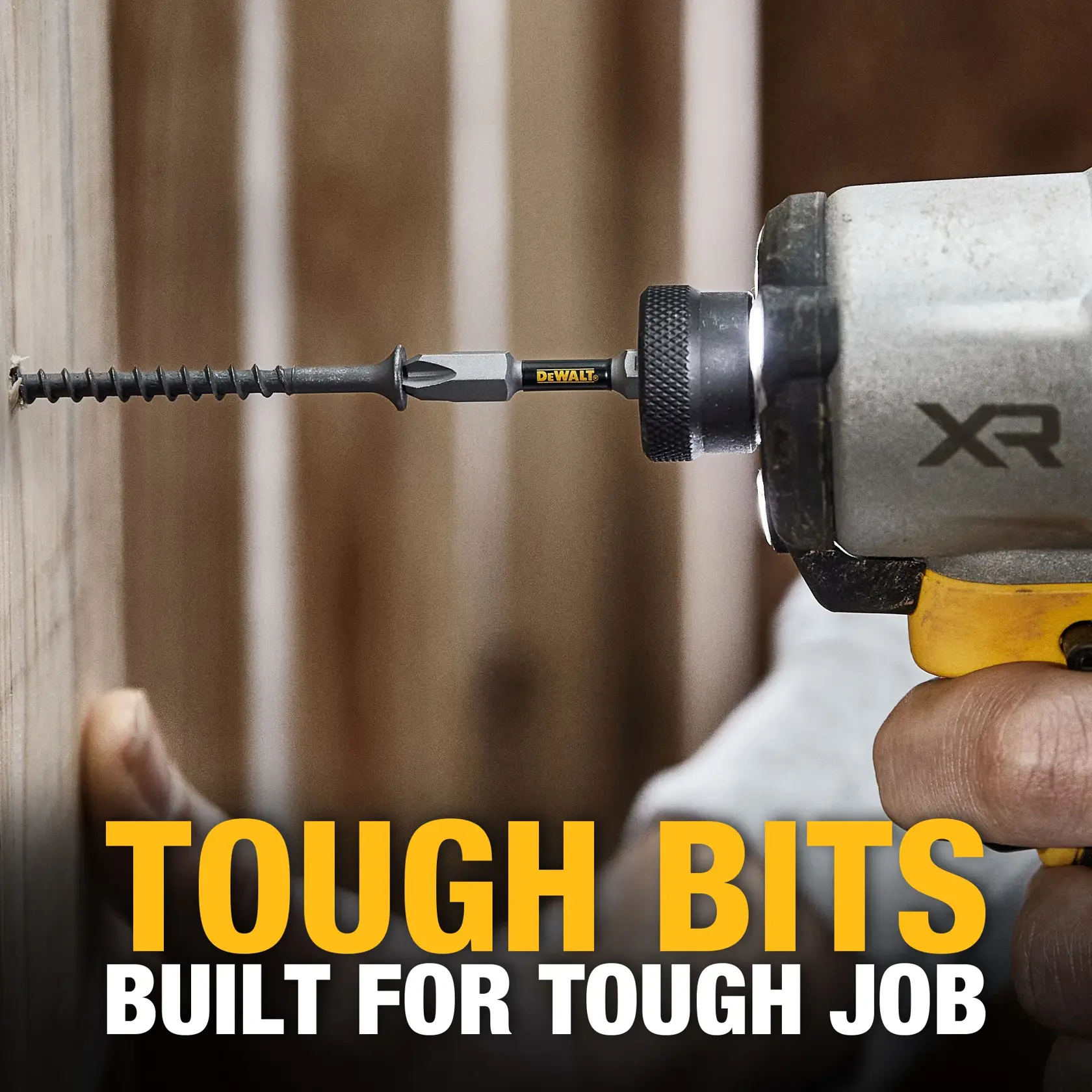 A close-up image of a DEWALT branded screwdriver bit attached to a power drill, driving a screw into wood. Text in the foreground reads 'TOUGH BITS BUILT FOR TOUGH JOB'.