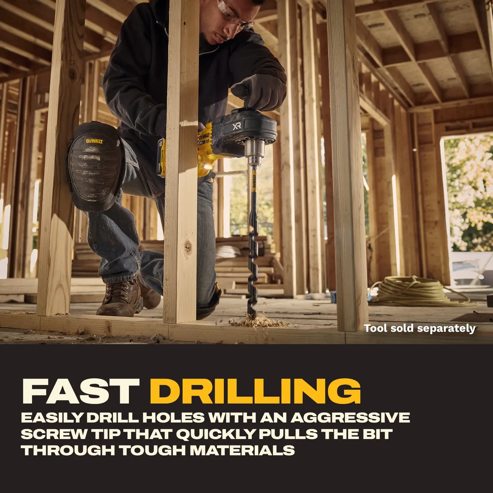 A person using a DEWALT drill with an auger bit to drill through wooden studs inside a construction site. The individual wears safety goggles and DEWALT knee pads. Text below describes fast drilling capability and features an aggressive screw tip for easy drilling through tough materials.