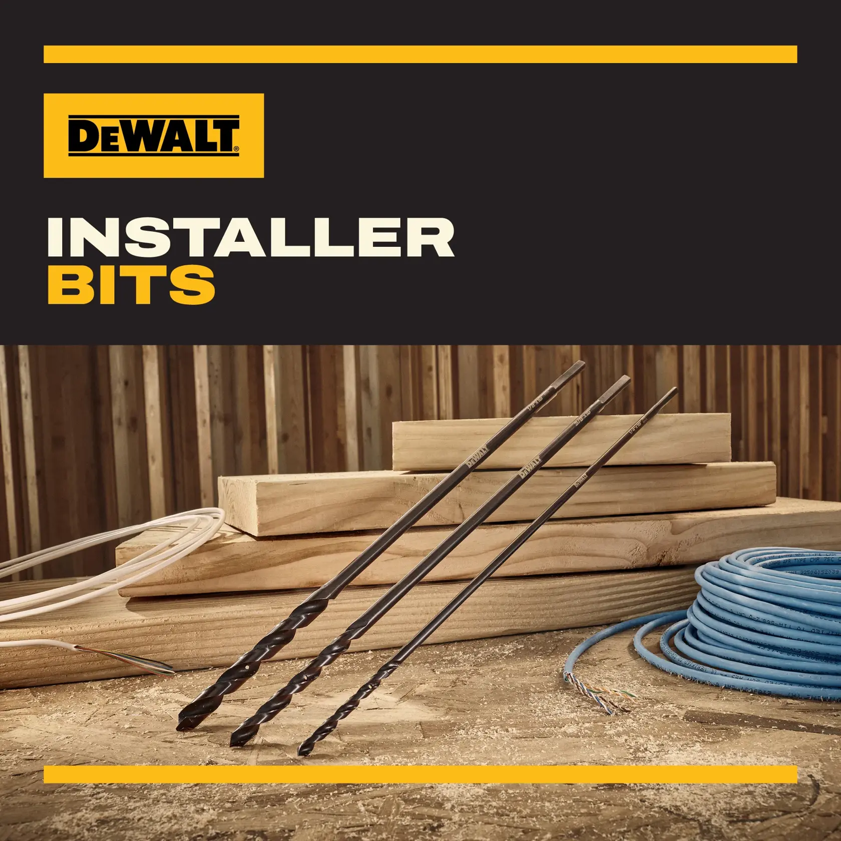 Three DEWALT installer bits are displayed on a work table with wood planks, coiled cables, and sawdust. The background includes a wooden wall, and the text 'DEWALT Installer Bits' is shown at the top.