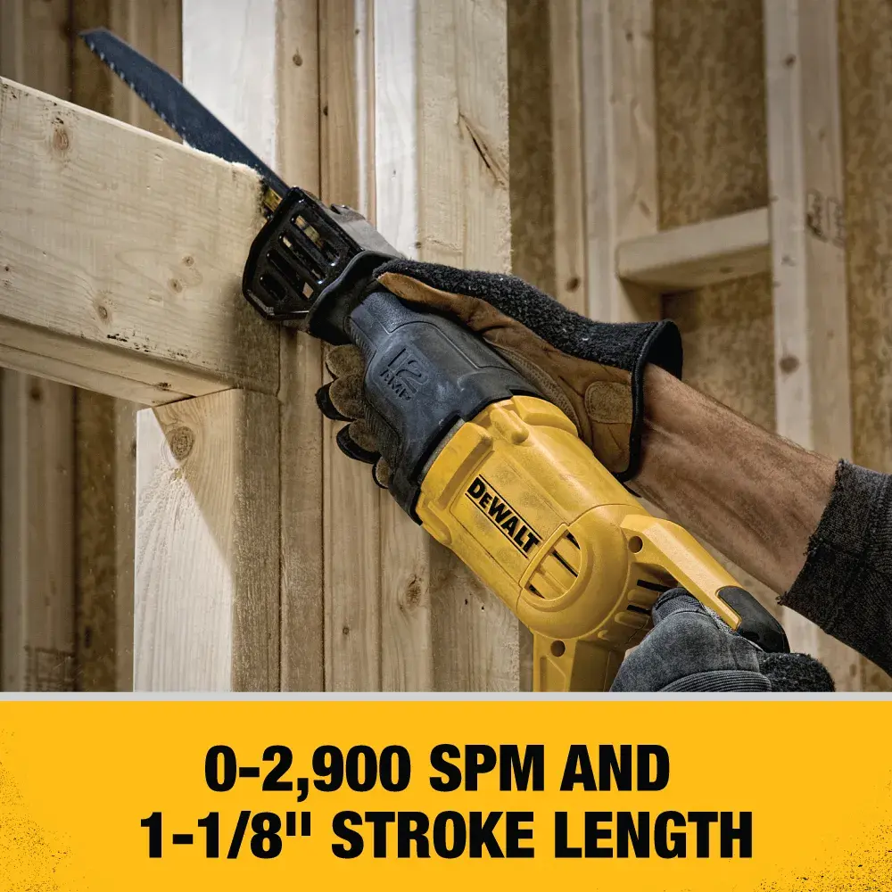 A person wearing protective gloves uses a yellow DEWALT DWE305 reciprocating saw to cut a metal pipe under a wooden ceiling or floor structure.