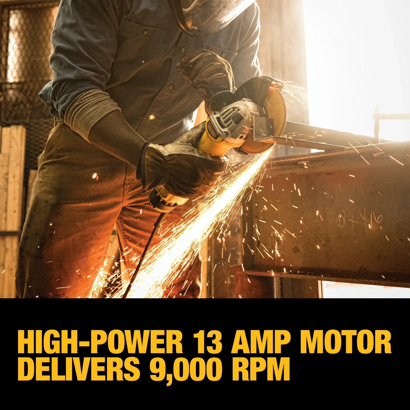 A person wearing protective gloves and a face shield is using a DEWALT angle grinder, generating sparks while working on a metal surface in an industrial workshop.