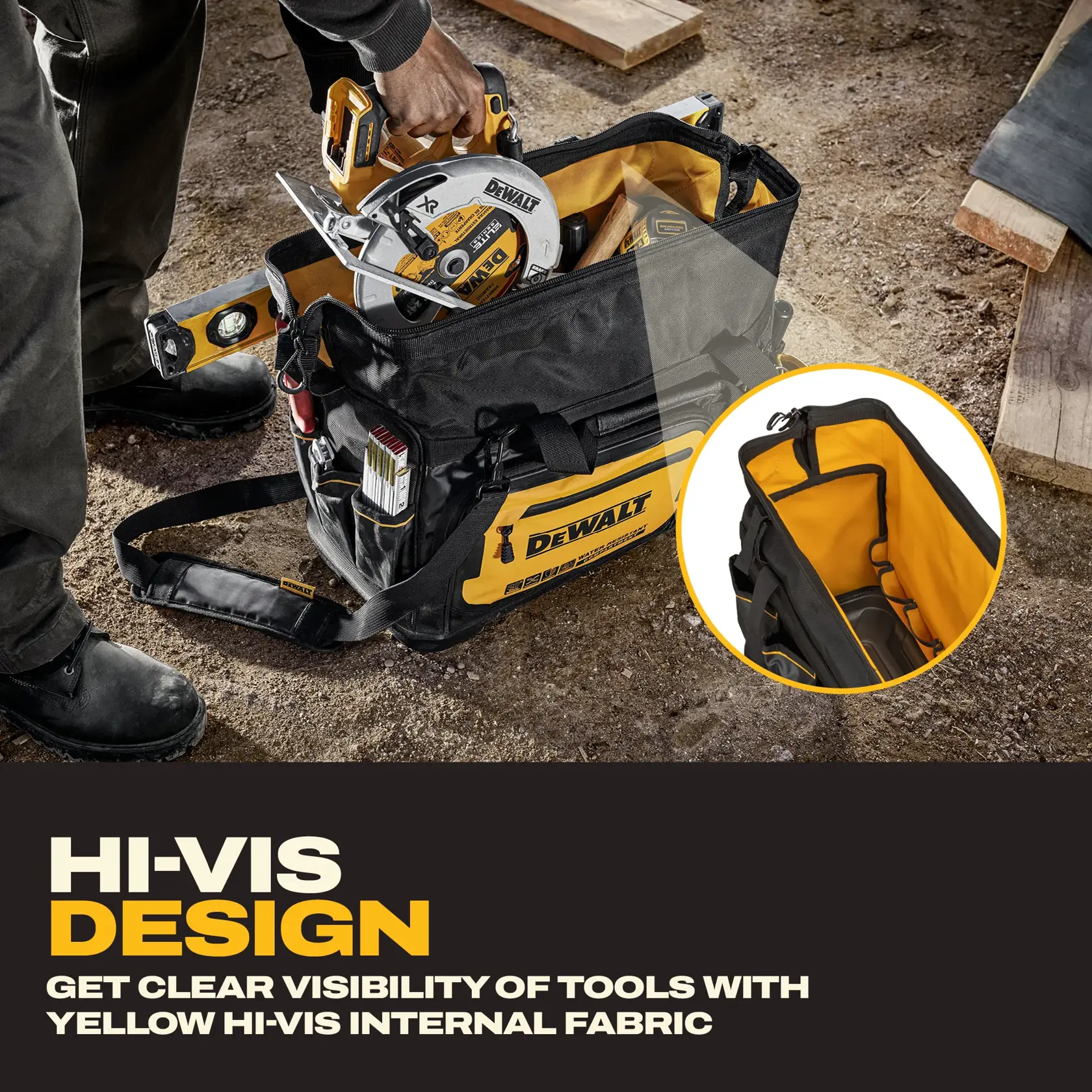 A person is placing a DEWALT circular saw into a black and yellow DEWALT tool bag at a construction site. The bag contains various tools including a spirit level and is set on a dirt ground with wooden planks nearby.