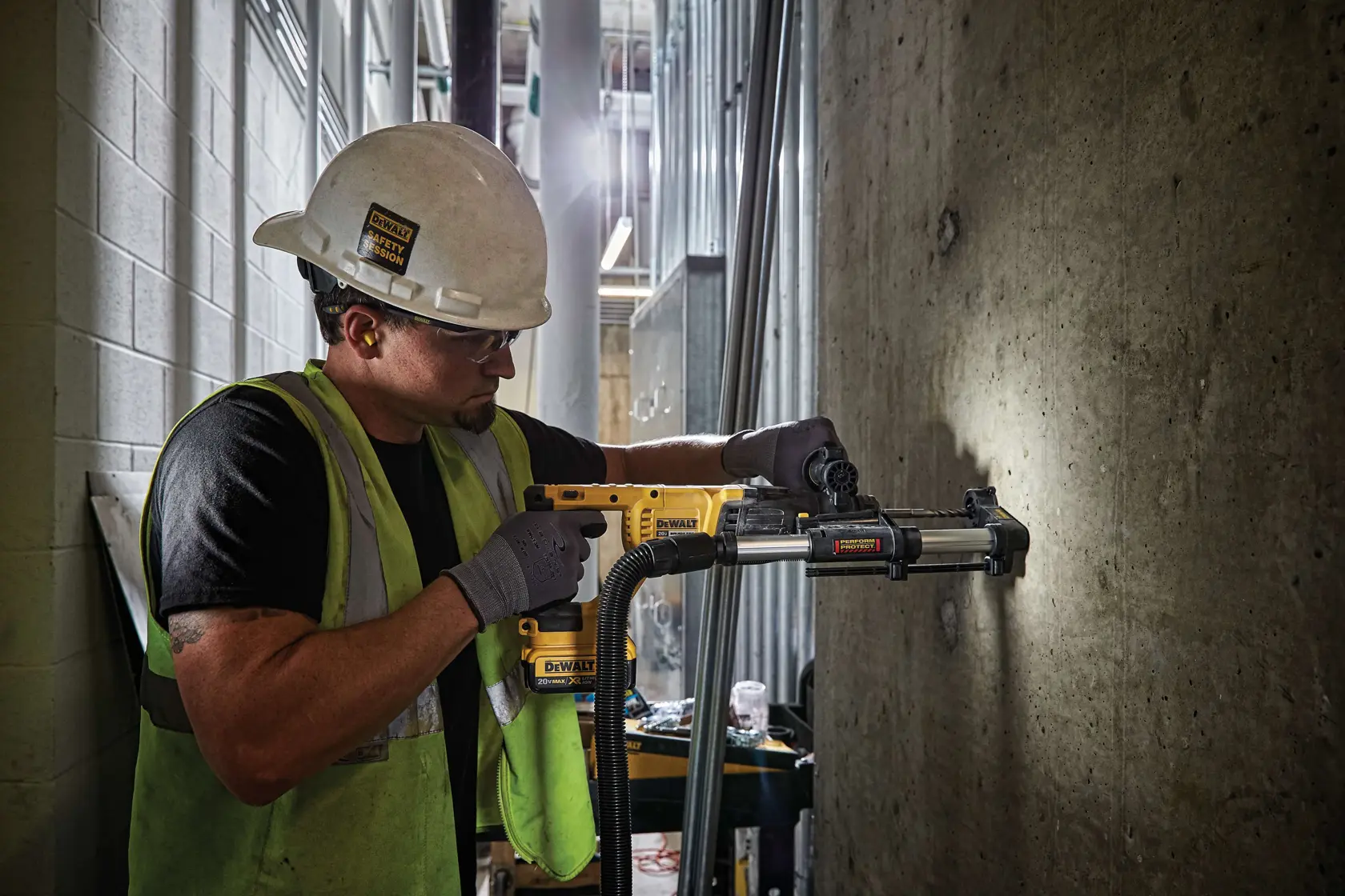 Rotary hammer with dust extractor telescope being used by person