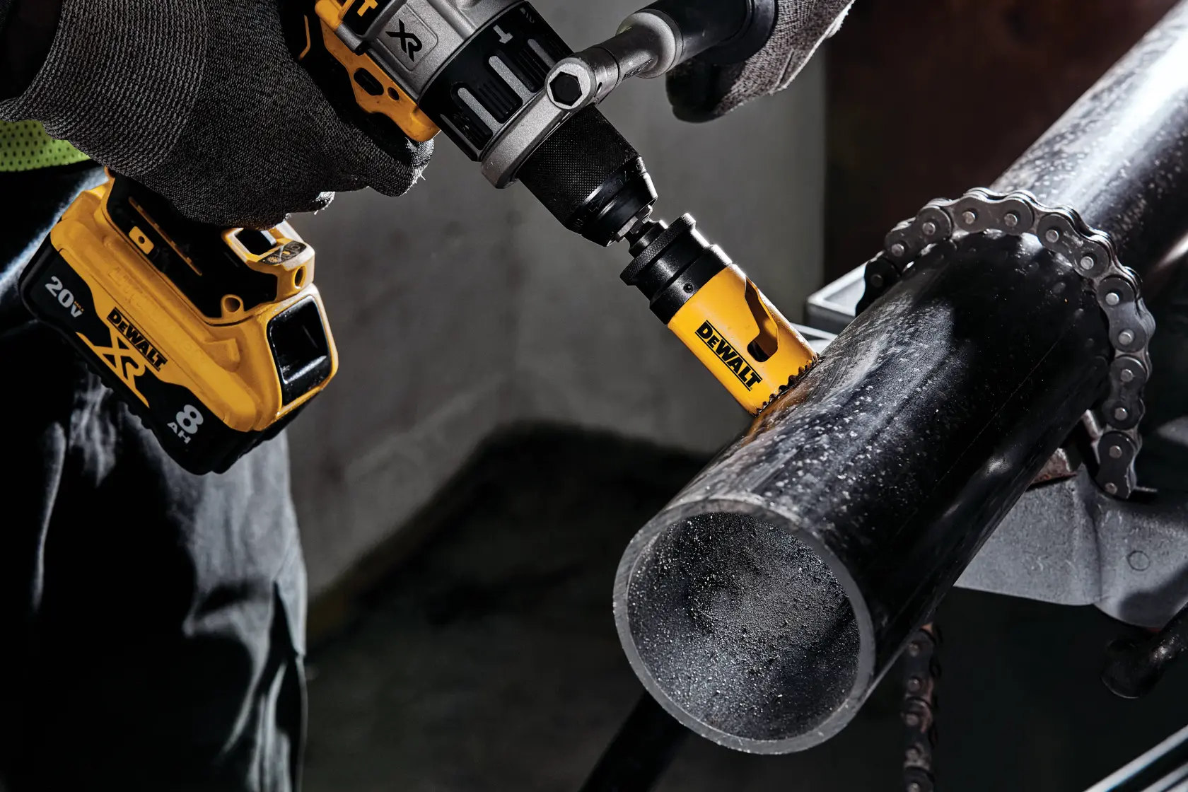 1 and 3 eighths inch Bi - Metal Hole Saw being used on a metal rod by a person.