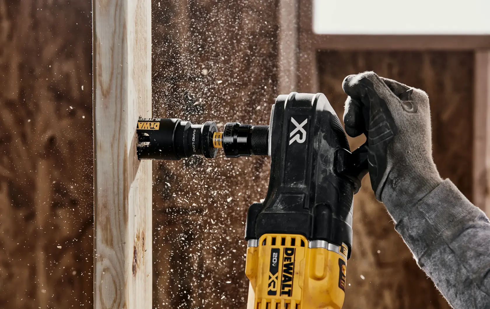 Person using ELITE SERIES Multi-Material Holesaw to cut wood