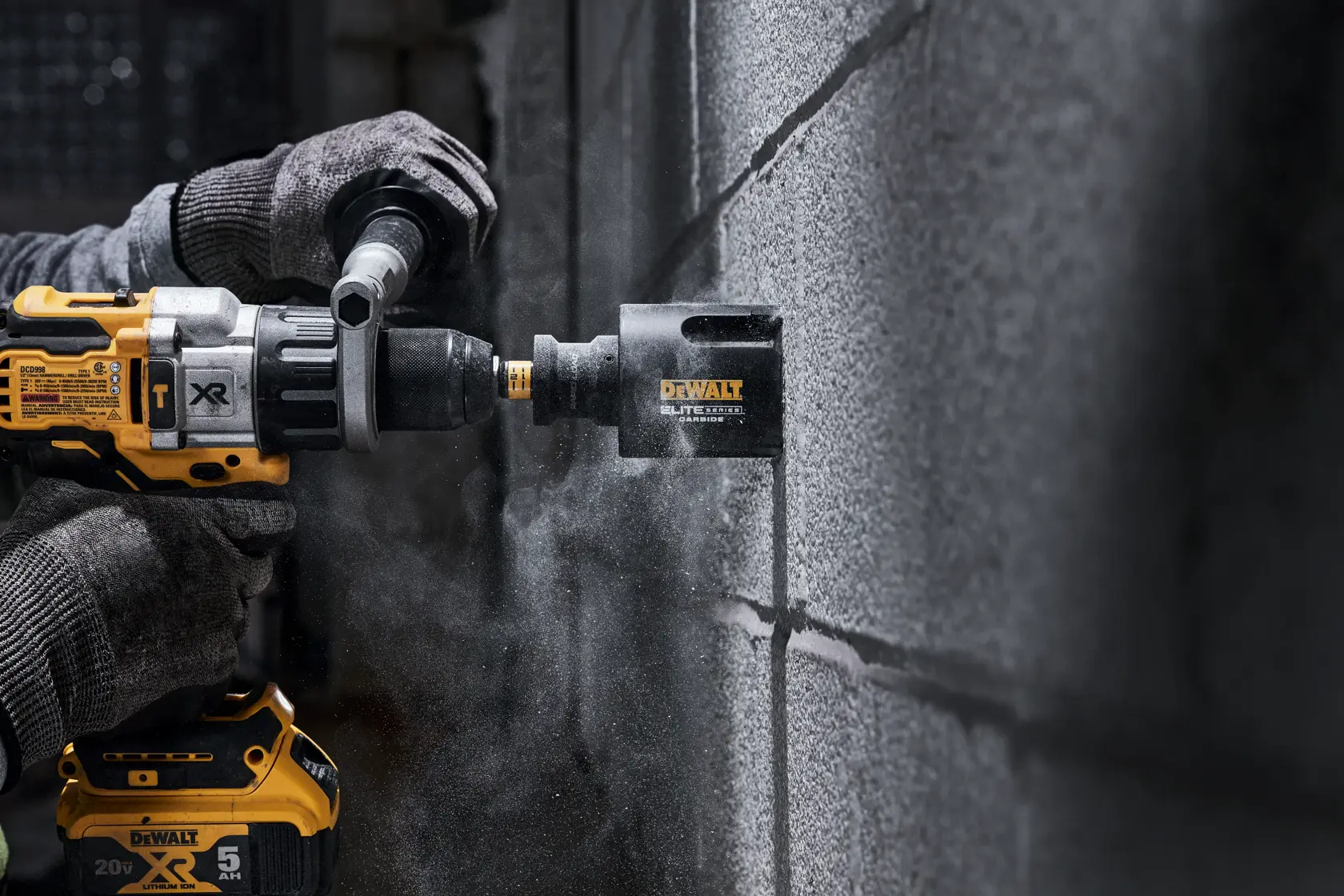 Person using ELITE SERIES Multi-Material Holesaw to cut through cement