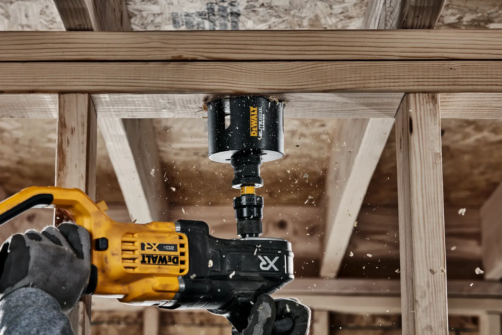 Person using ELITE SERIES Multi-Material Holesaw to cut wood