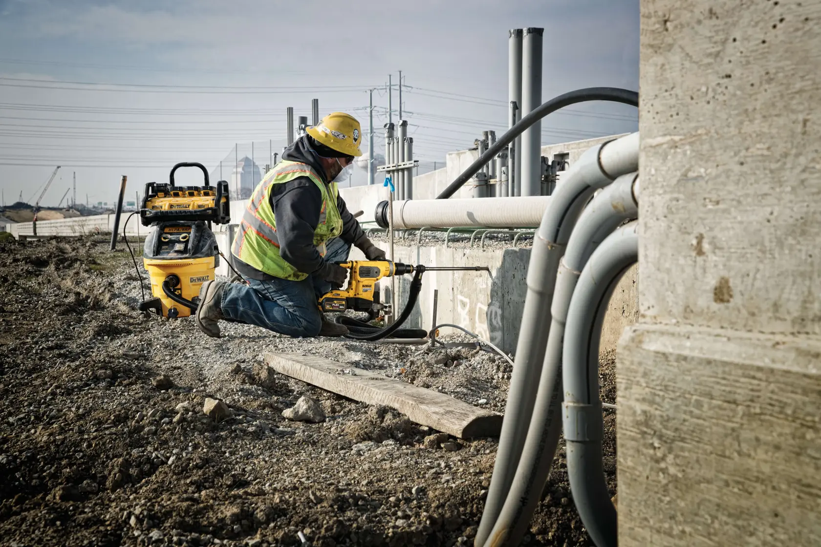 1800 Watt Portable Power Station and Battery Charger being used by a construction worker to power up a drill at a construction site