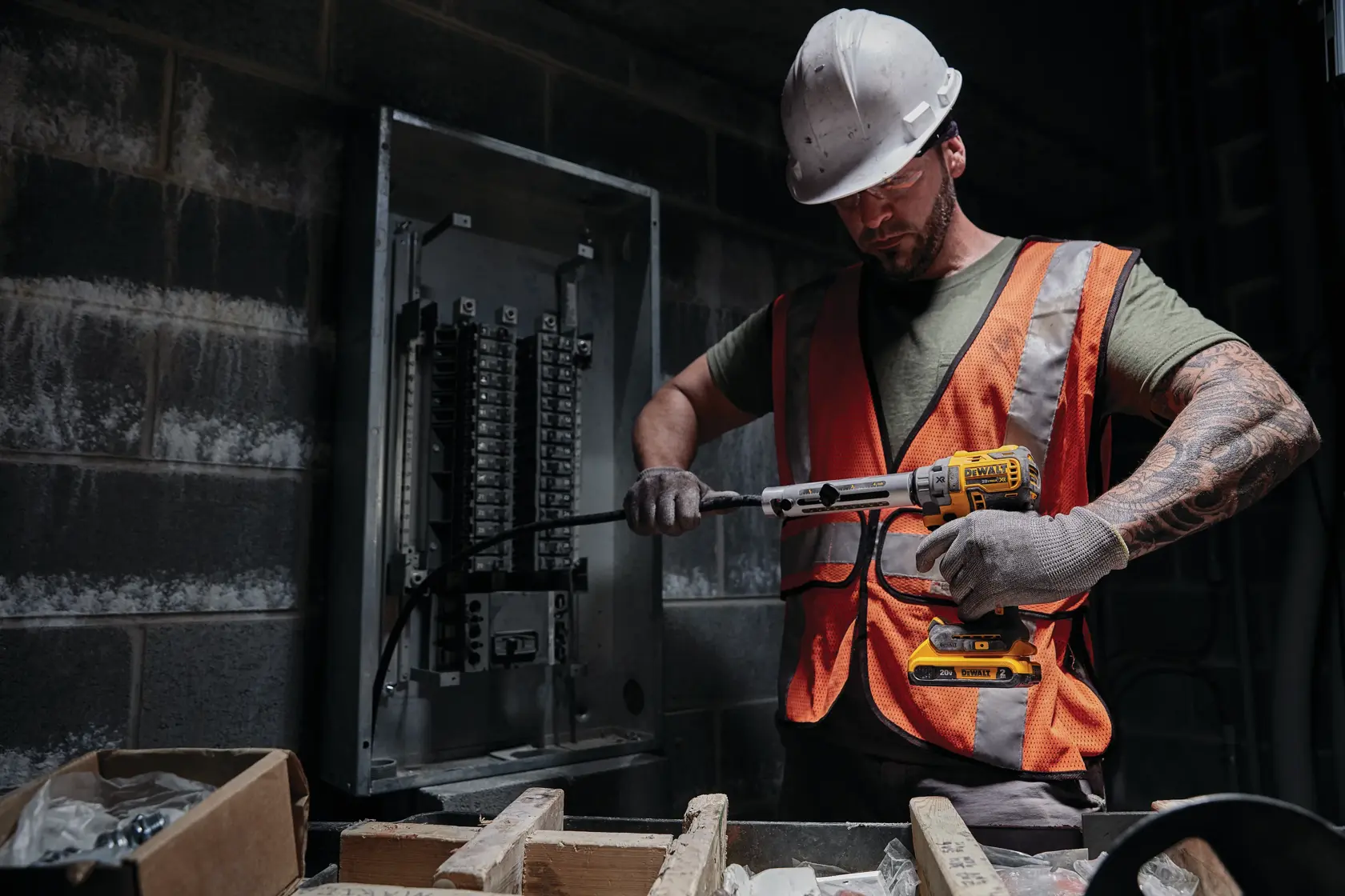 20 Volt Compact Lithium-Ion Battery being used by a construction worker to power up a drill