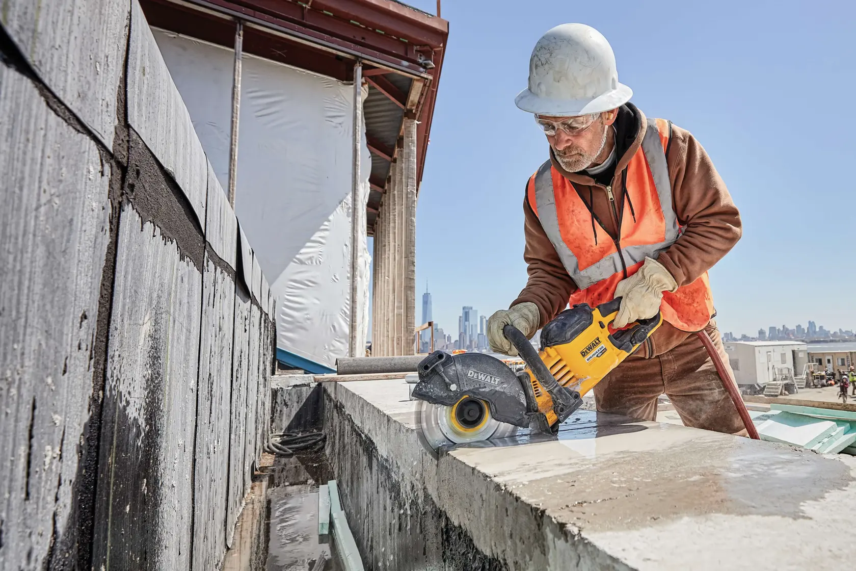 20 Volt to 60 Volt 9 AMP hours Lithium-Ion Battery-powered Circular Saw being used by a construction worker to cut concrete at a construction site