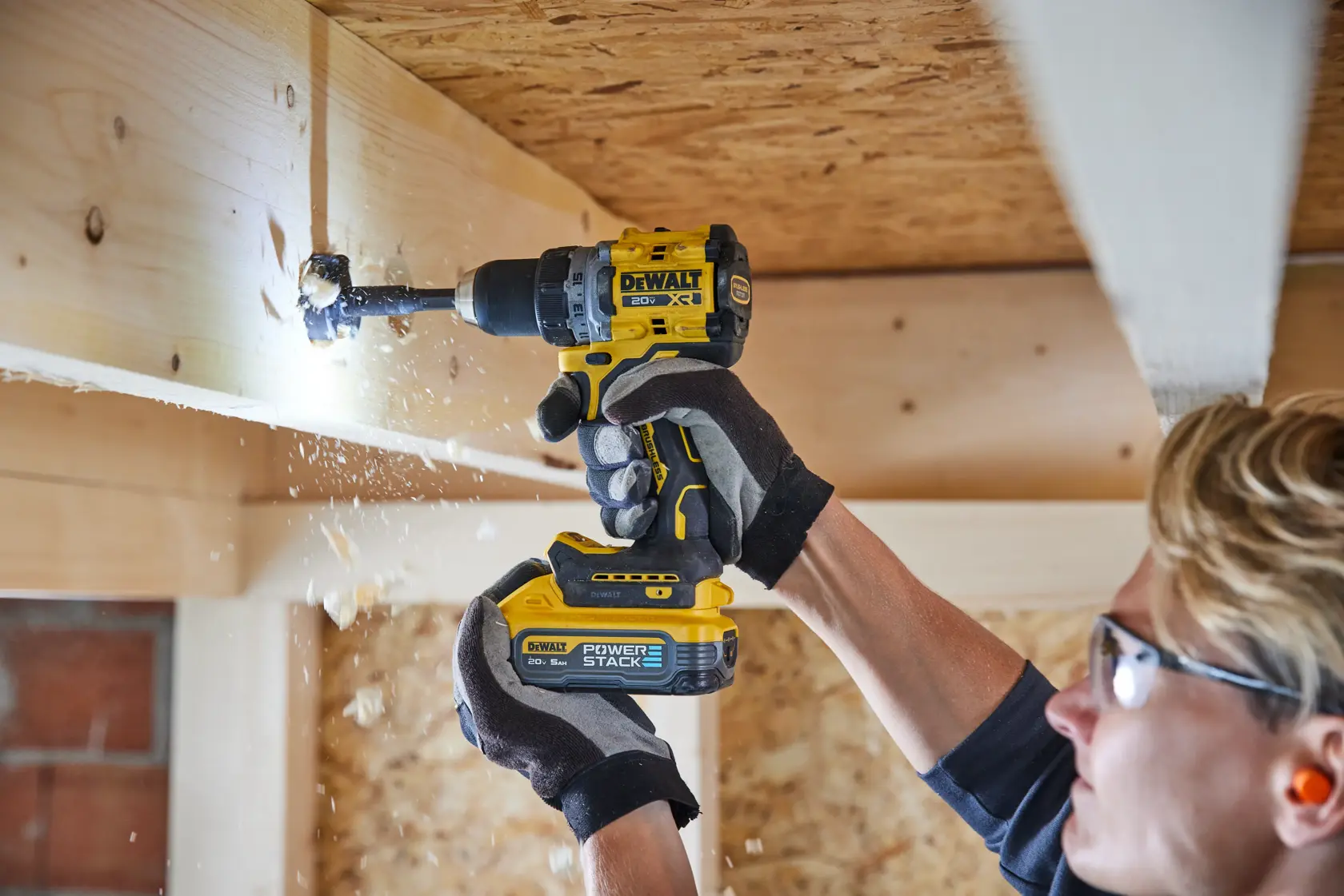 Drill being used overhead with DEWALT POWERSTACK five amp hour battery 