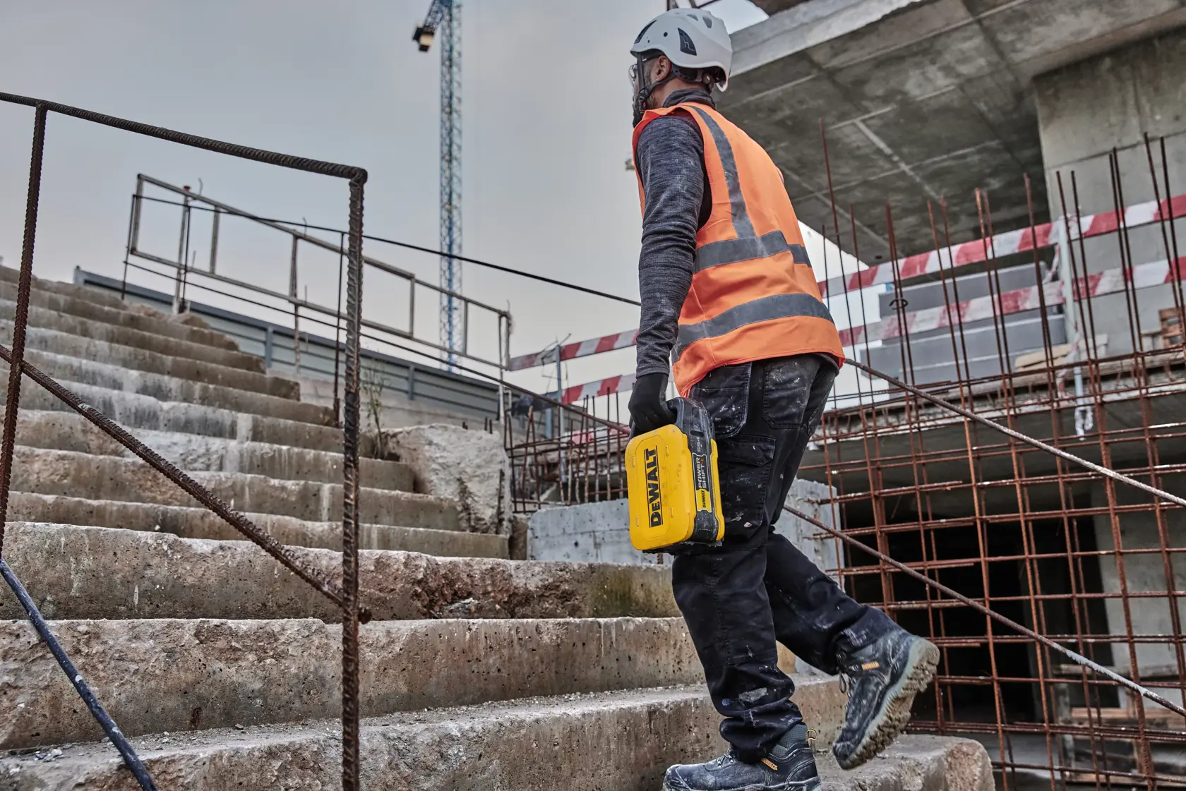 Man carrying battery up steps