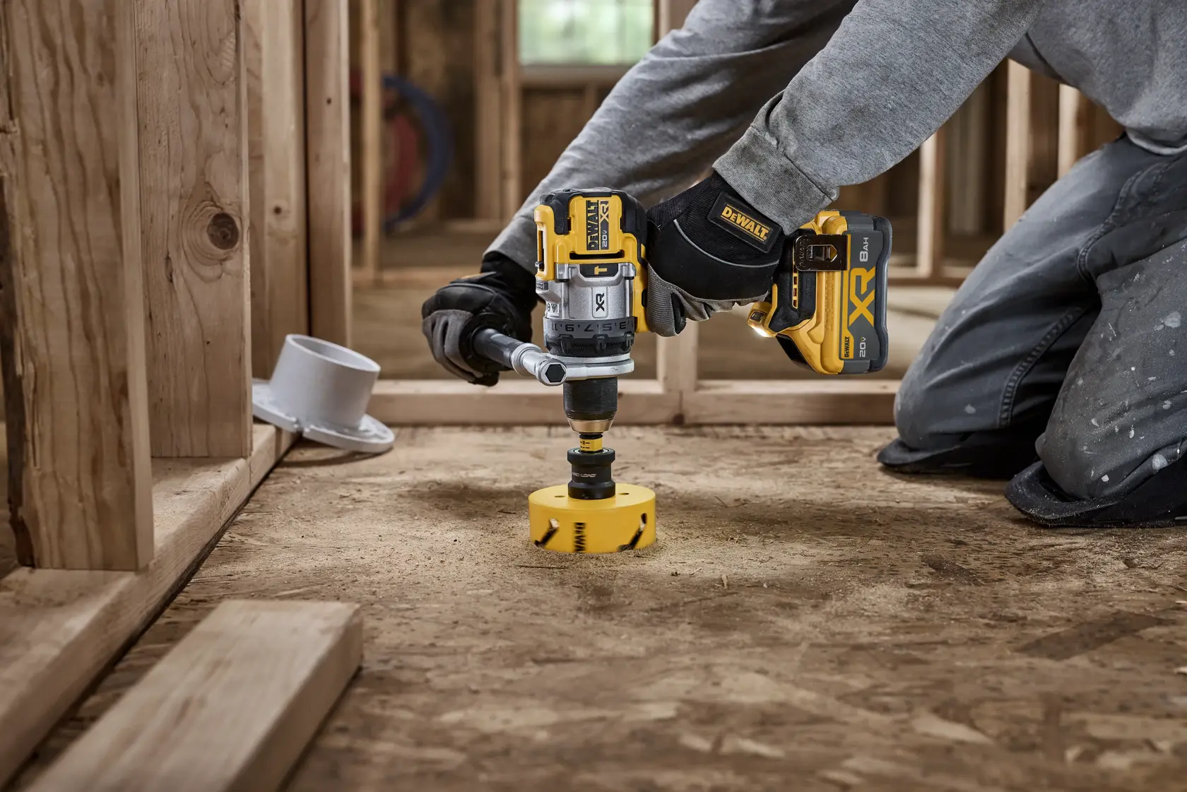 20V MAX* XR® Brushless Cordless 1/2 in. Hammer Drill drilling 4“ hole for plumbing using a DEWALT hole saw