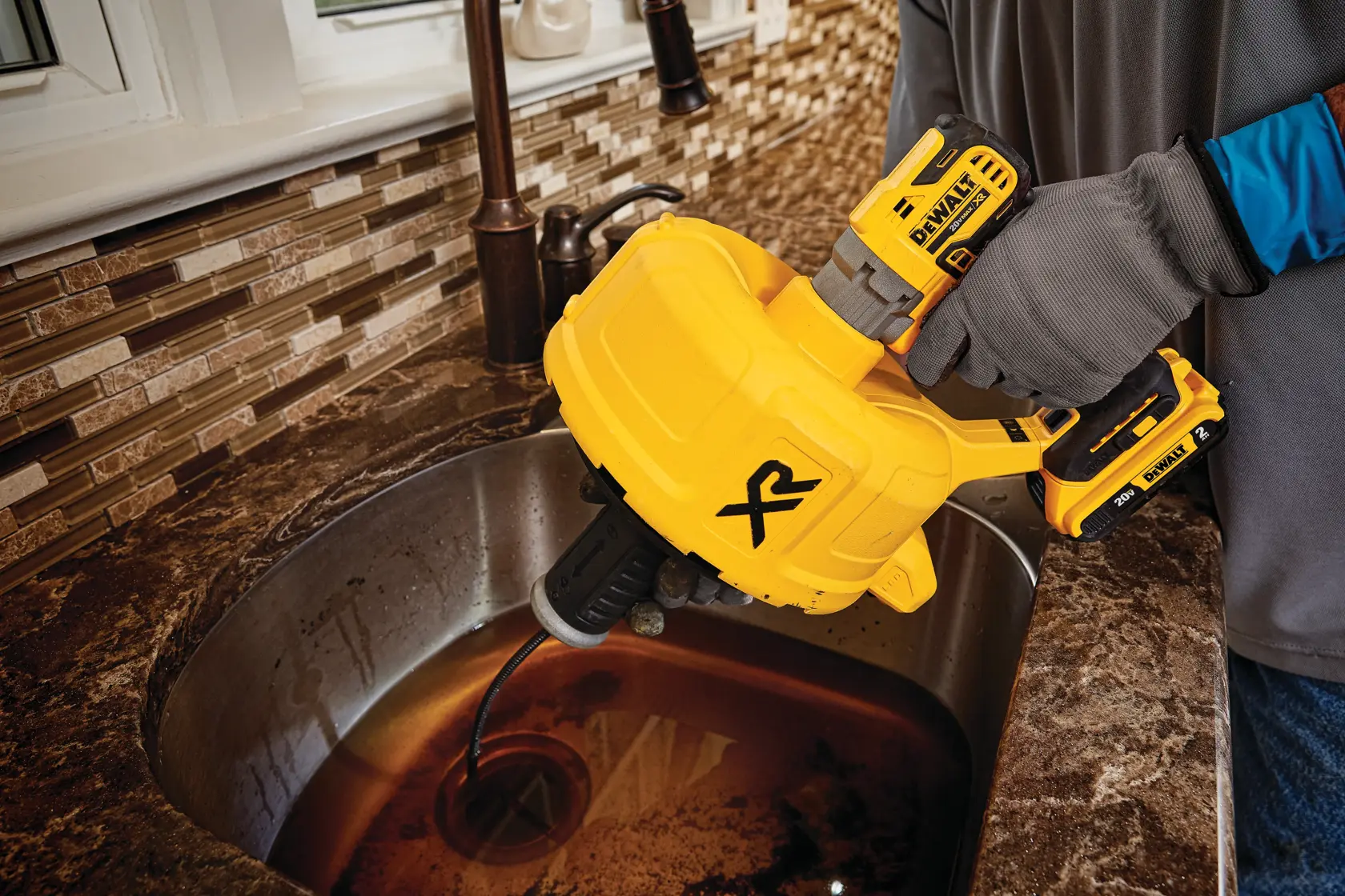 XR Brushless cordless drain snake clearing  drain from  sink.