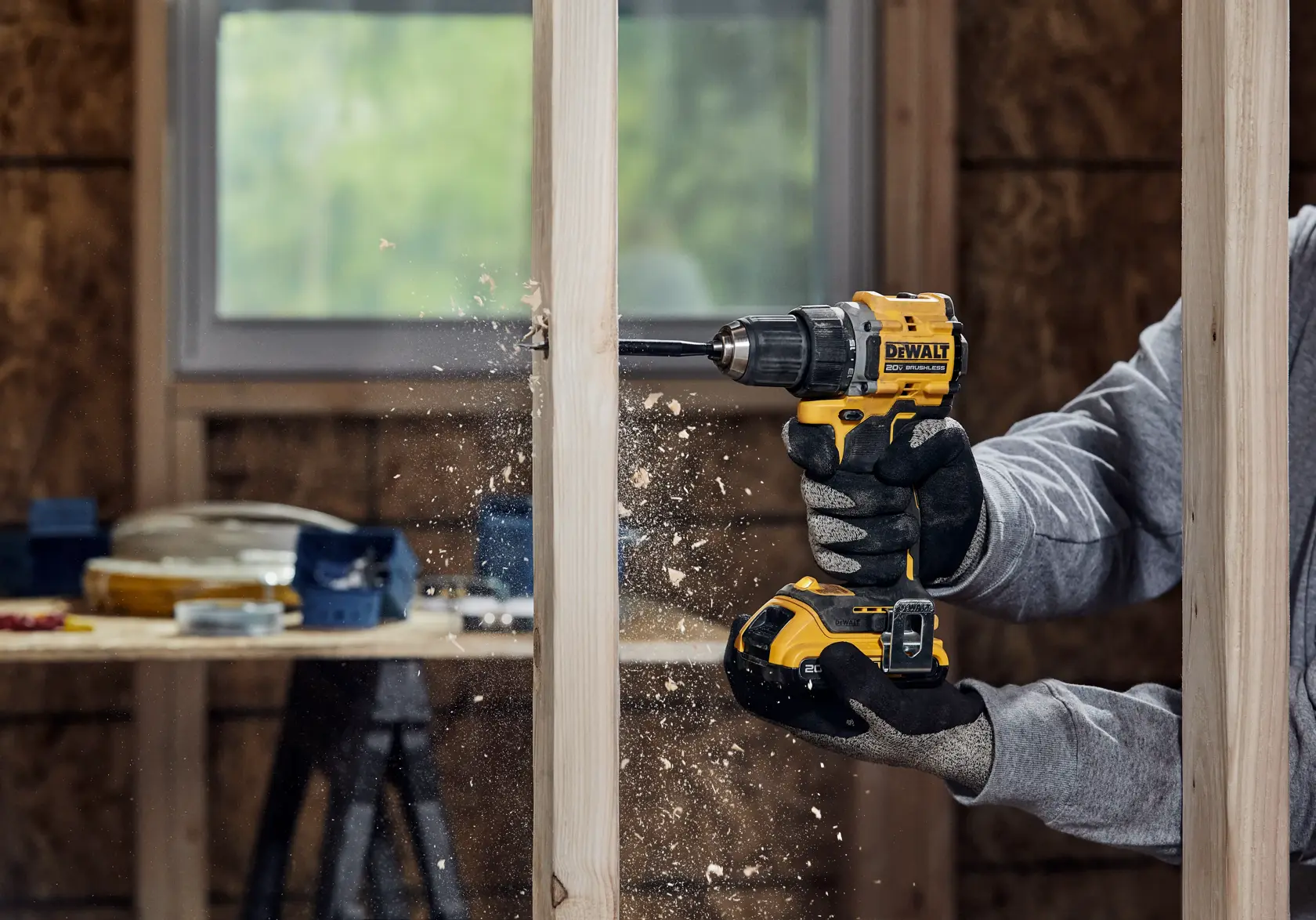 ATOMIC COMPACT SERIES(™)20V MAX Brushless Drill/Driver drilling into a wood framing