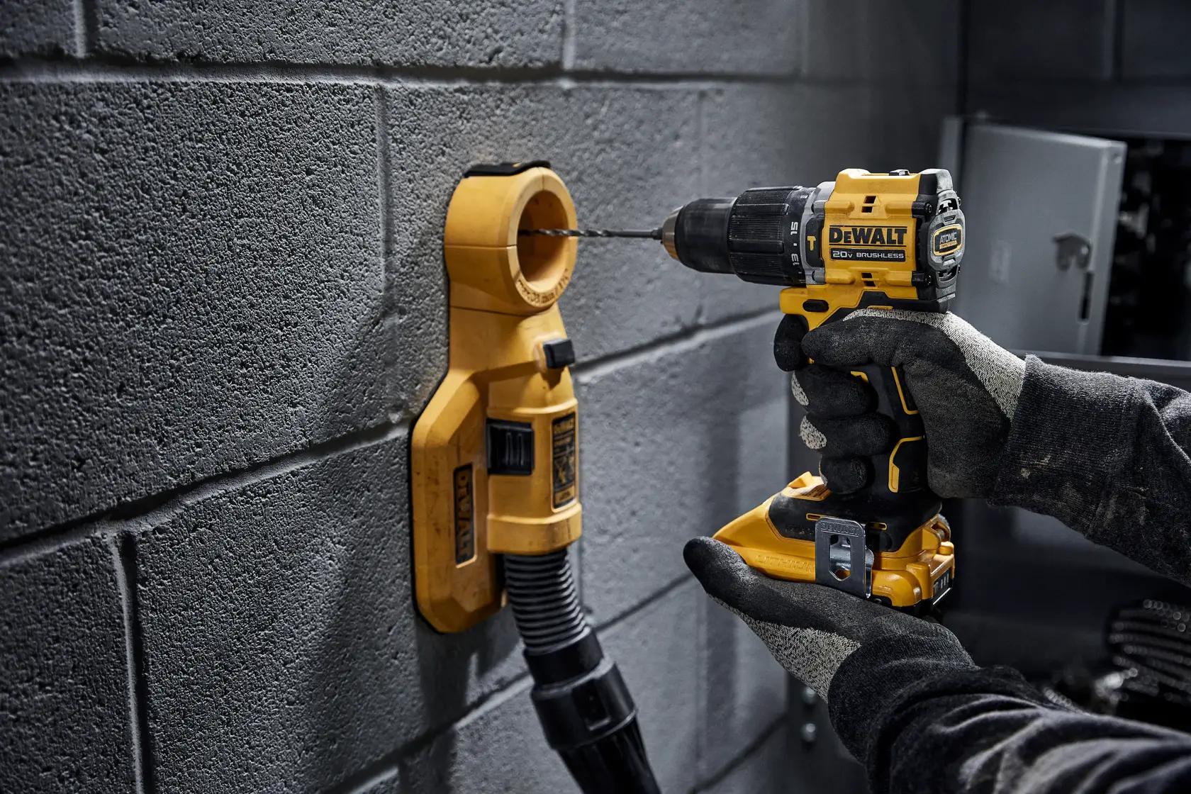 ATOMIC COMPACT SERIES()™ 20V MAX Brushless Hammer Drill drilling into concrete wall