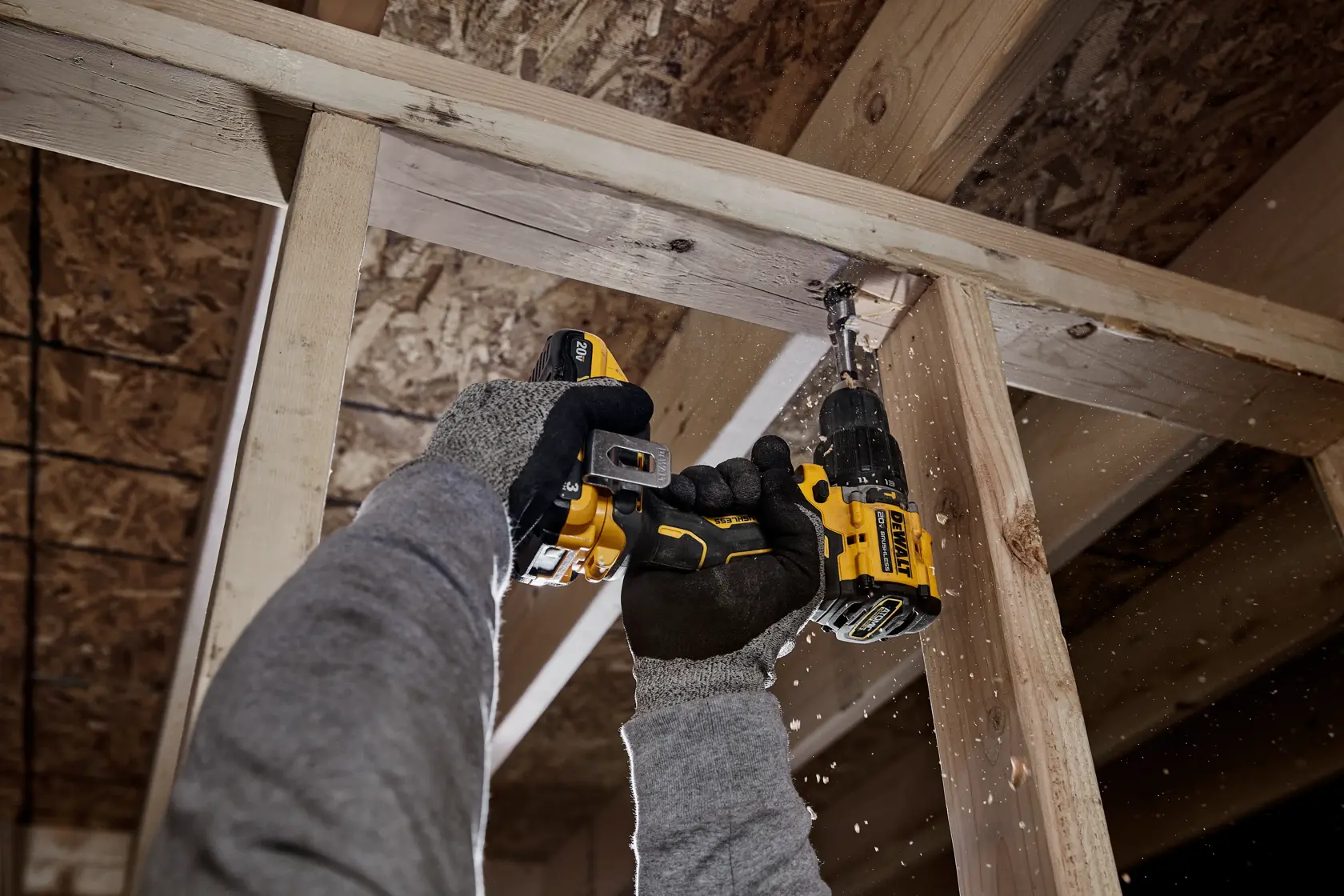 ATOMIC COMPACT SERIES(™) 20V MAX Brushless Hammer Drill drilling into wood framing