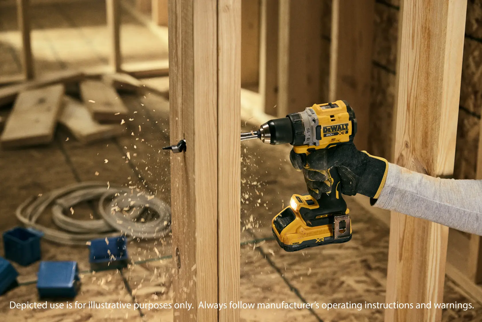 A person using a DEWALT cordless power drill to drill a hole in a wooden beam at a construction site. Wood shavings are visible around the drilling area.