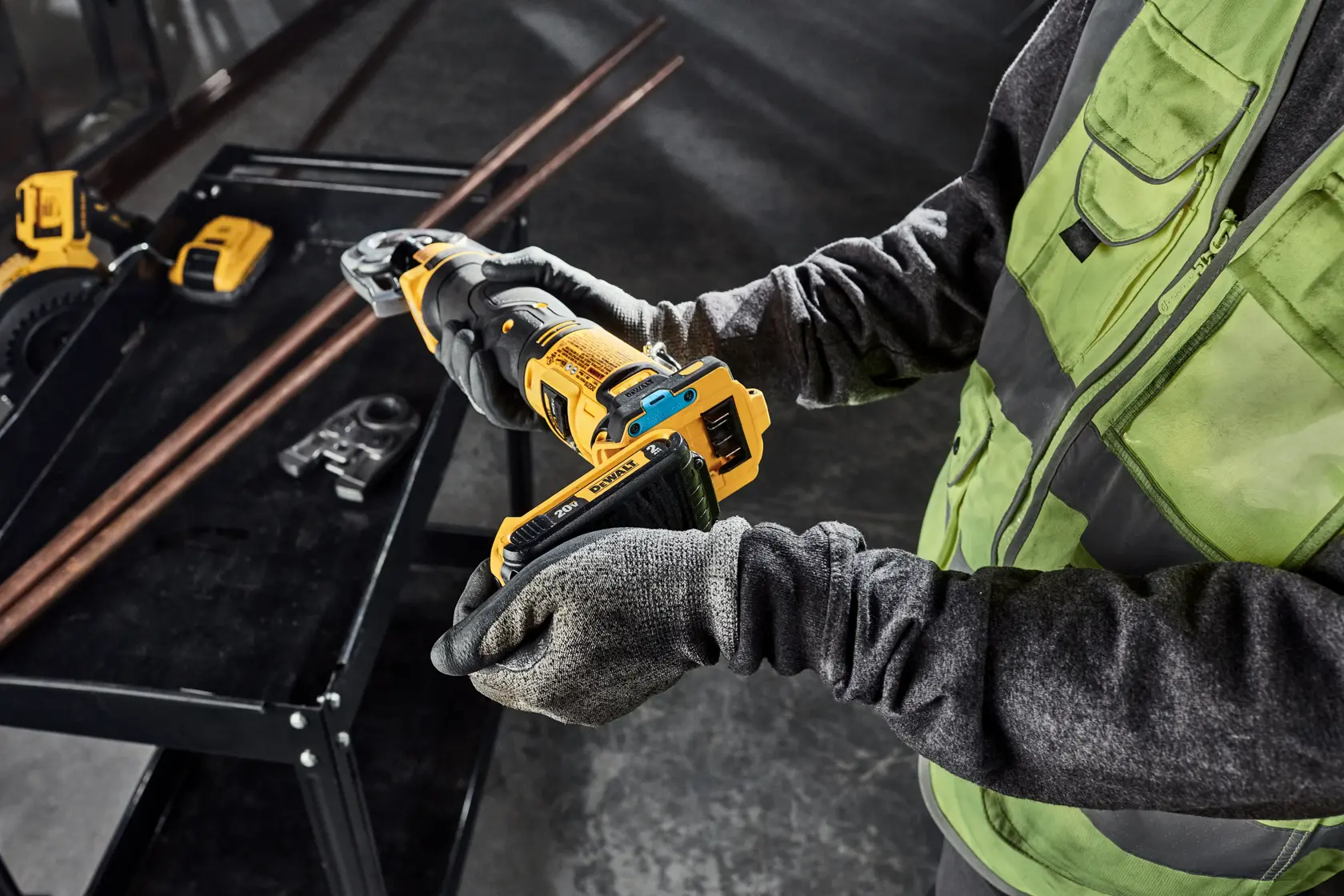 Tradesman is putting a 2AH battery on the DEWALT Compact Press Tool; you can also see the tool connect chip installed.