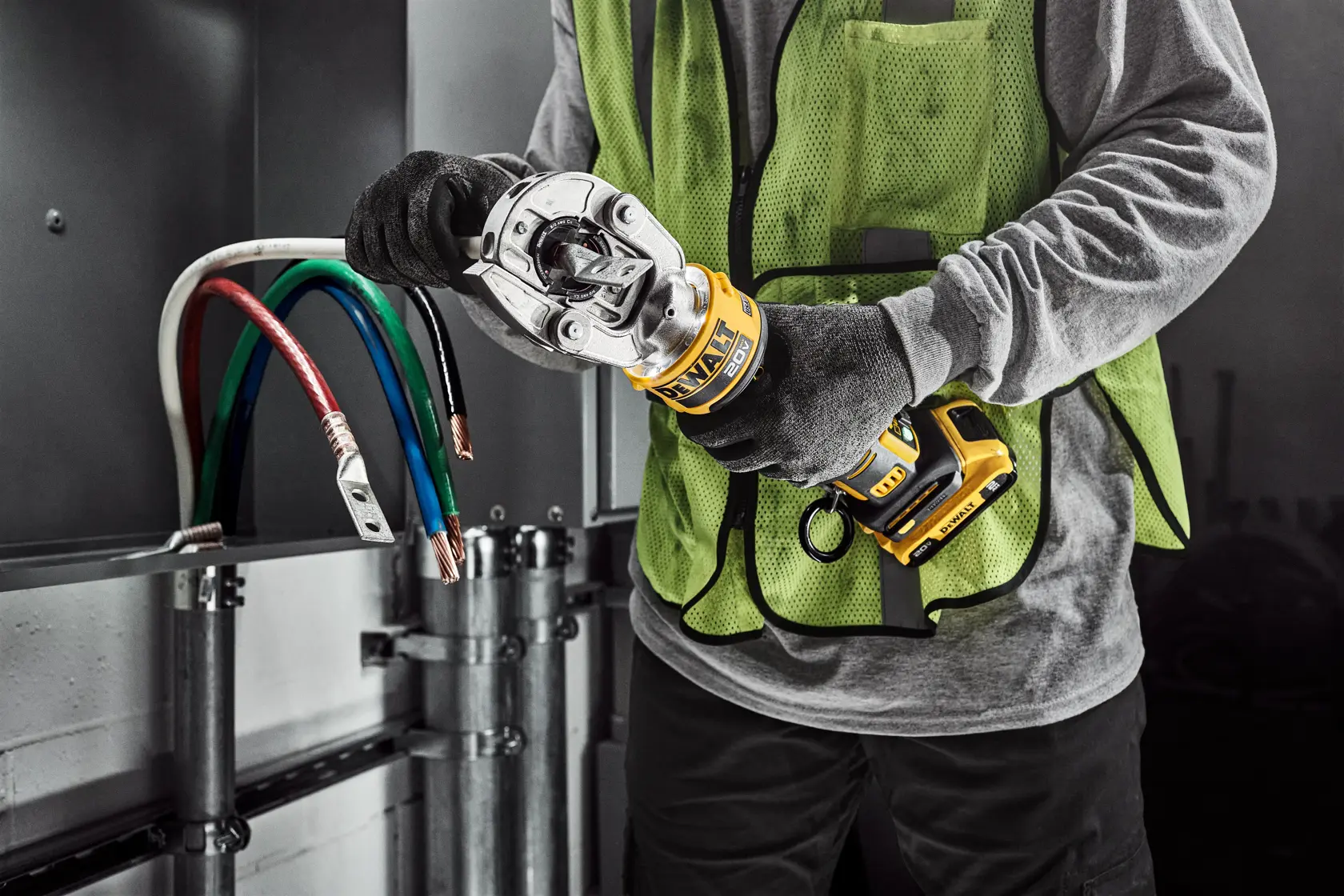 DEWALT Cable Crimper crimping a lug on to a white cable in an electrical room.