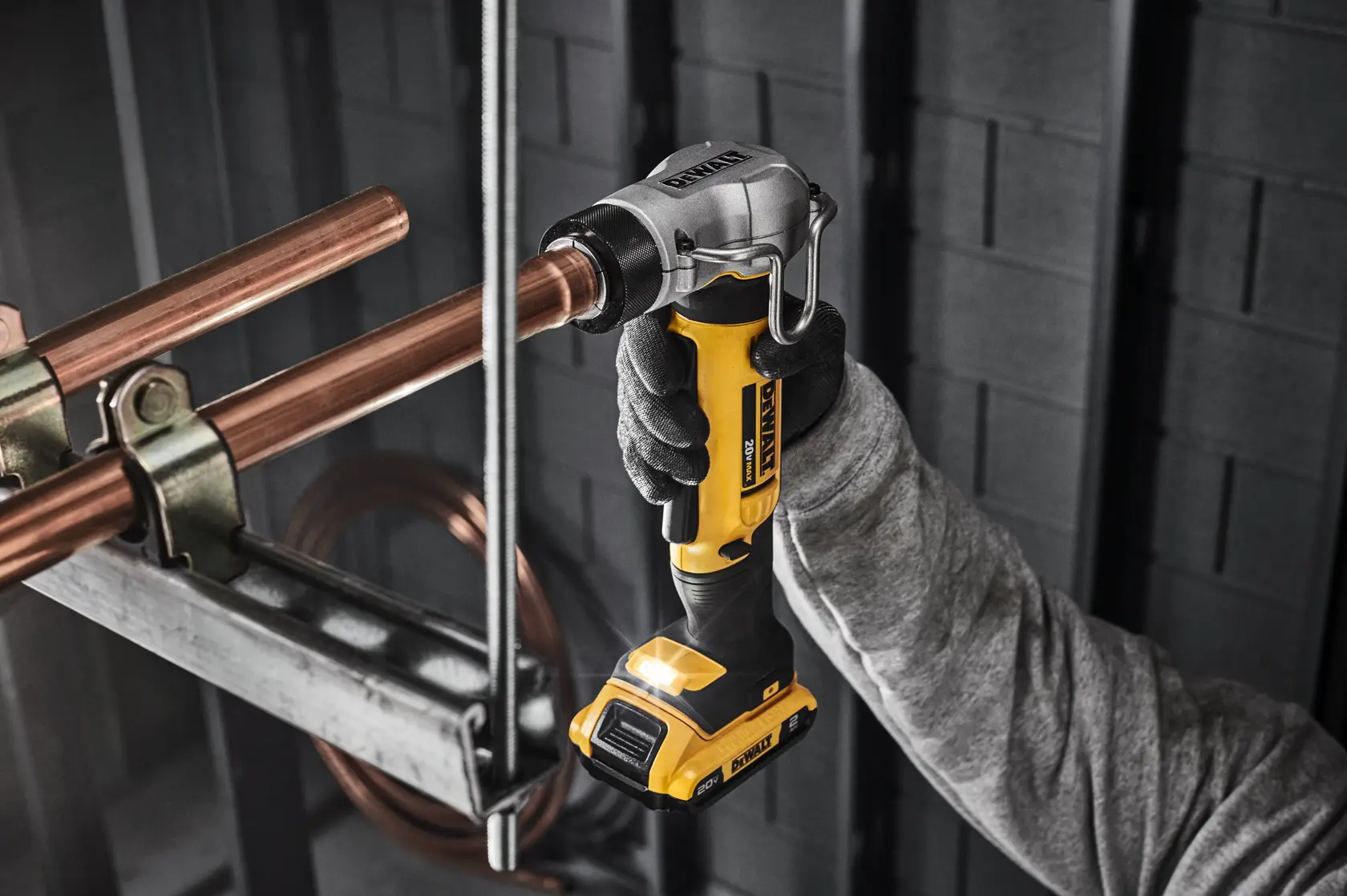 DEWALT 20V MAX* Swage Tool with 2 Ah Battery expanding copper pipe in commercial setting. 