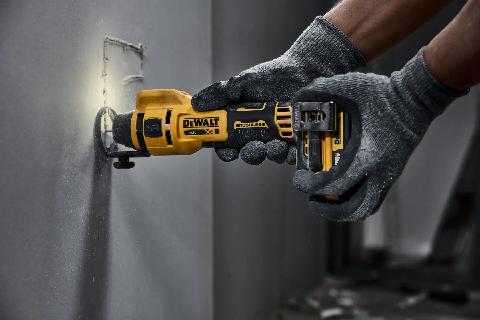 individual using a 20V MAX XR(®) Brushless Drywall Cutout Tool on a wall