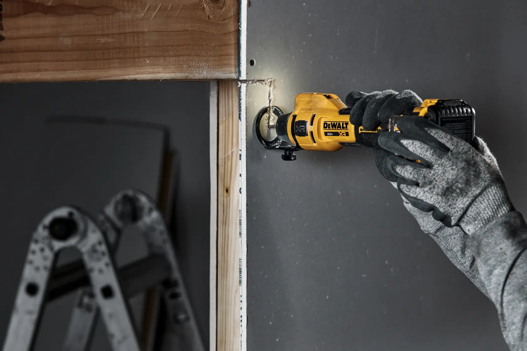 individual using a 20V MAX XR(®) Brushless Drywall Cutout Tool on a residential wall