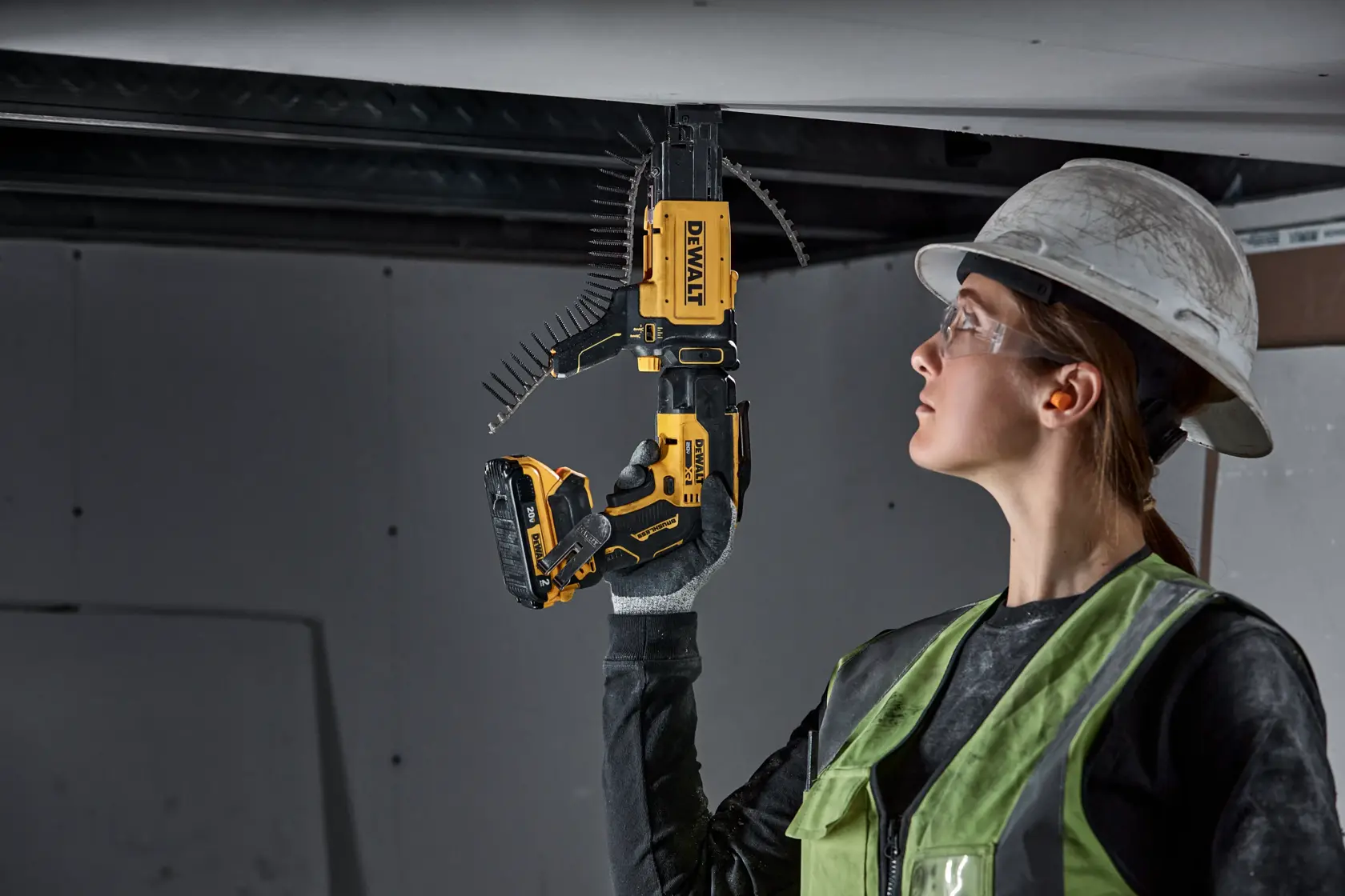 individual using a 20V MAX XR(®) Brushless Drywall Screwgun with collated attachment on ceiling