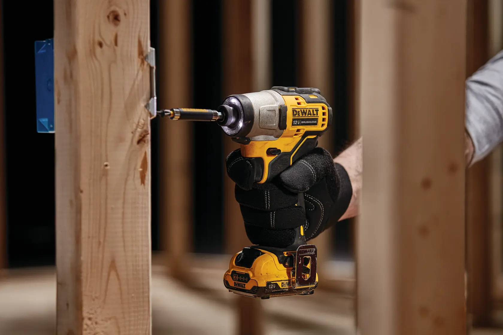 XTREME Brushless cordless impact driver being used on wooden beam.