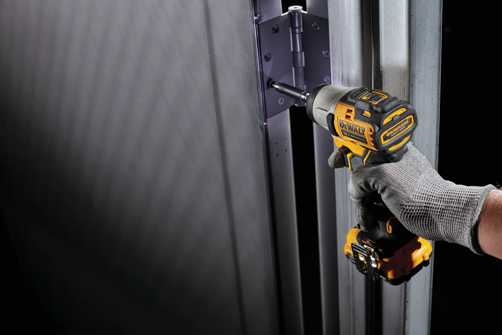 XTREME Brushless cordless impact driver fastening screw in hinge.