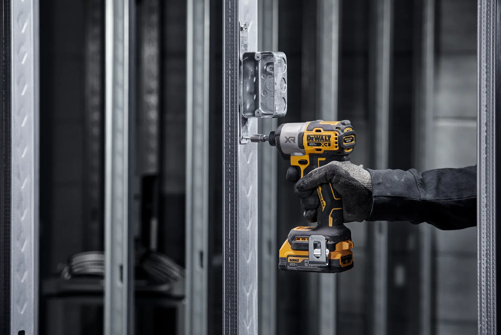 DCF845 20V MAX 1/4 inch 3-Speed Impact Driver with DEWALT POWERSTACK(™) fastening a screw into metal post