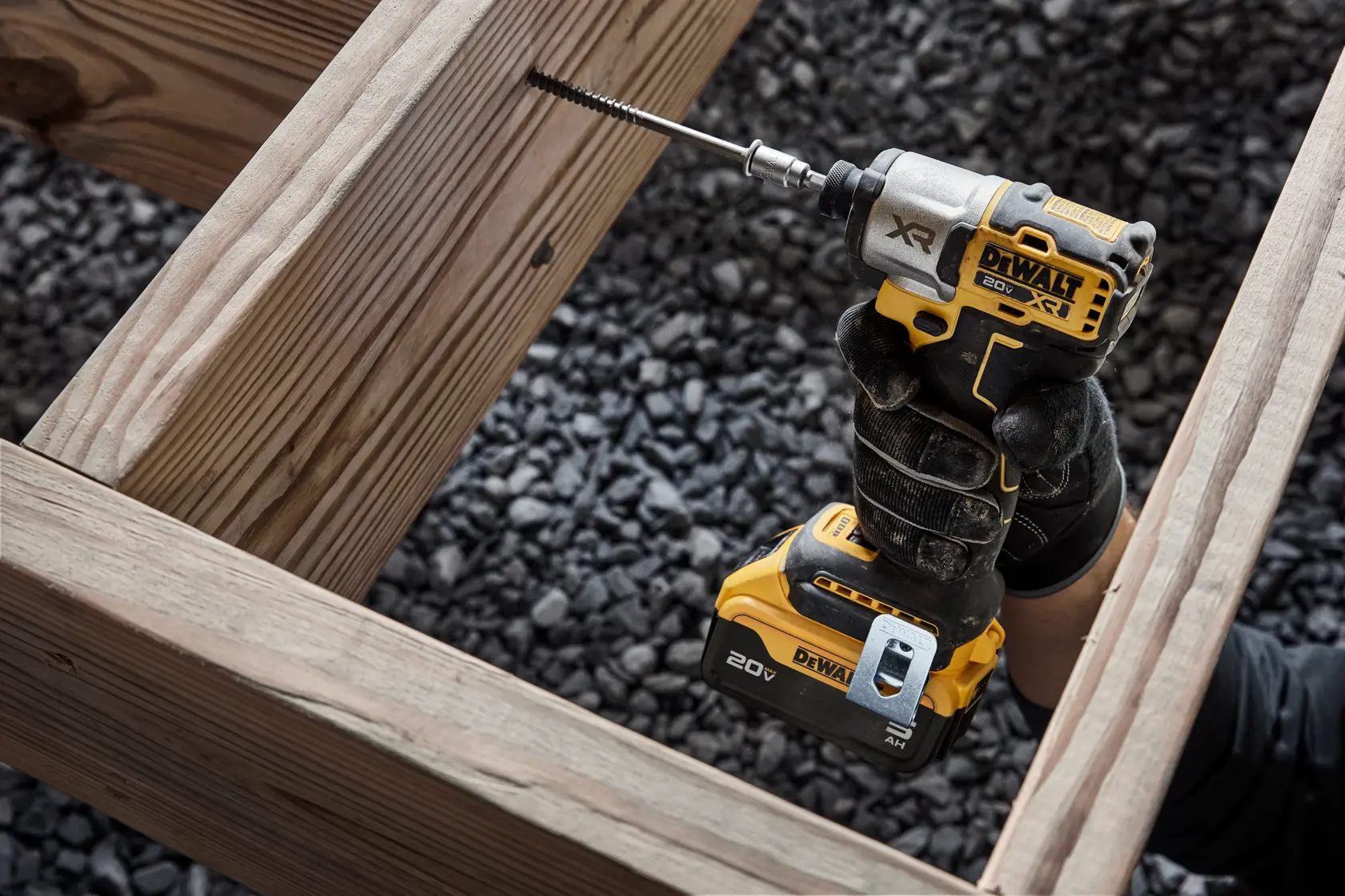 DCF845 20V MAX 1/4 inch 3-Speed Impact Driver fastening a large screw into a deck board