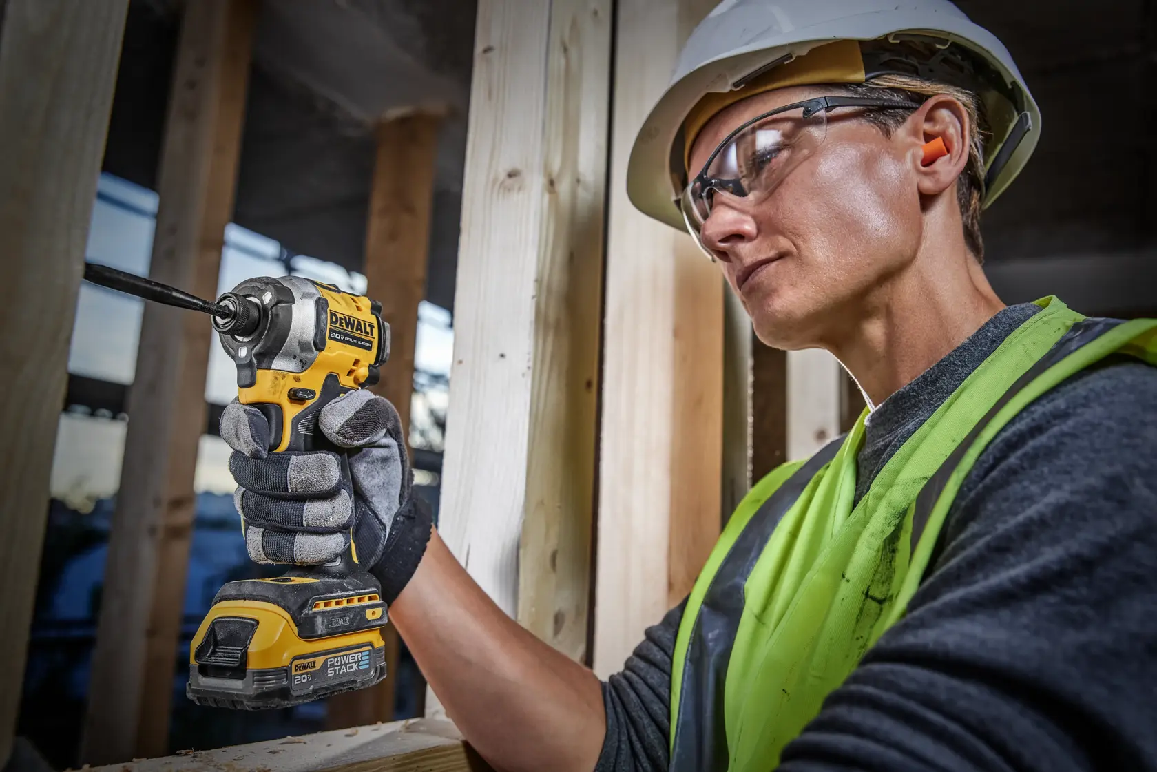 Impact driver drilling into wood with users body in frame 