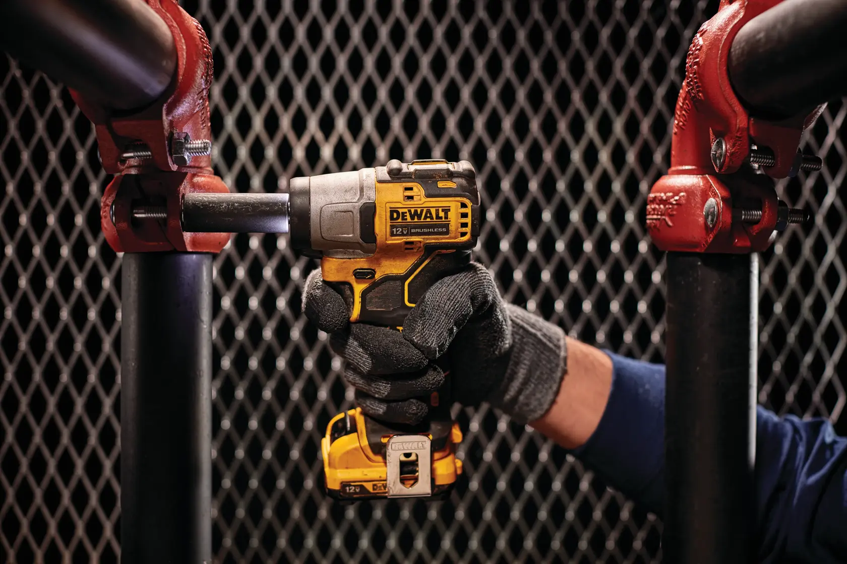 CORDLESS IMPACT WRENCH being used by a person