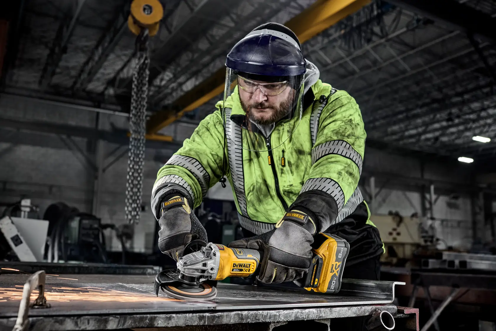 DEWALT 20V MAX* XR®  4-1/2 in. - 5 in. Angle Grinder grinding sheet metal in a commercial setting. 